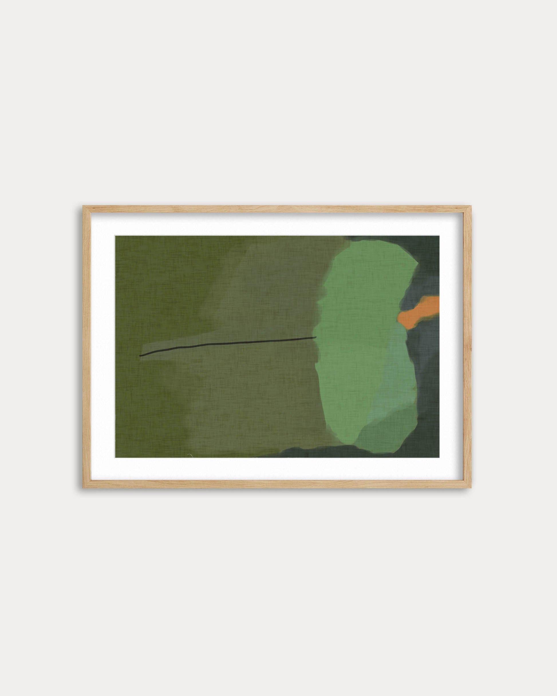 Framed abstract art piece with green and orange shapes on a white wall