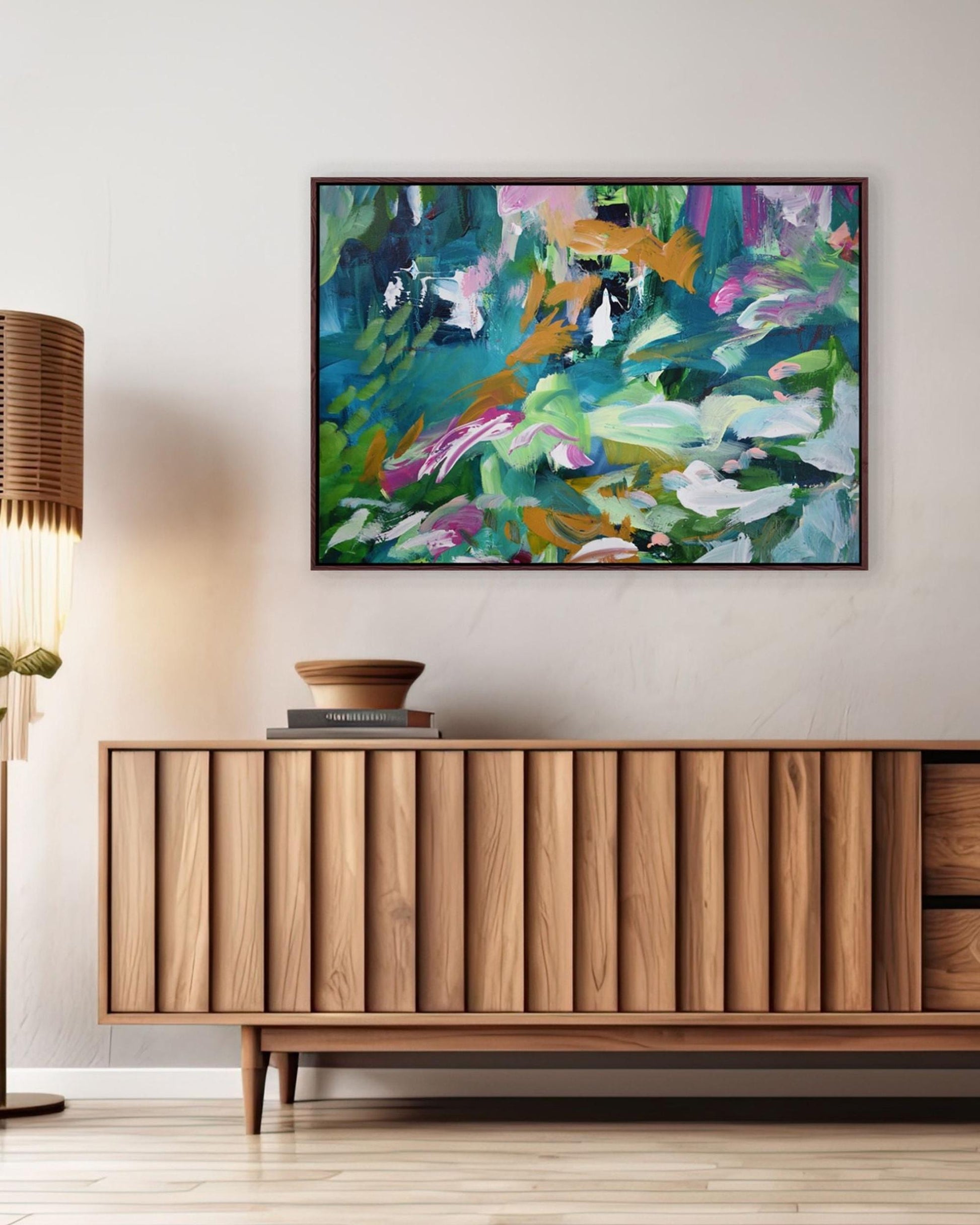 Modern living room with wooden sideboard, lamp, and abstract painting