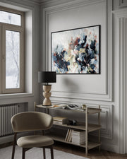 Modern interior with a desk, chair, and abstract painting on a wall.