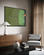 Modern living room with abstract art, wooden sideboard, and gray armchair.