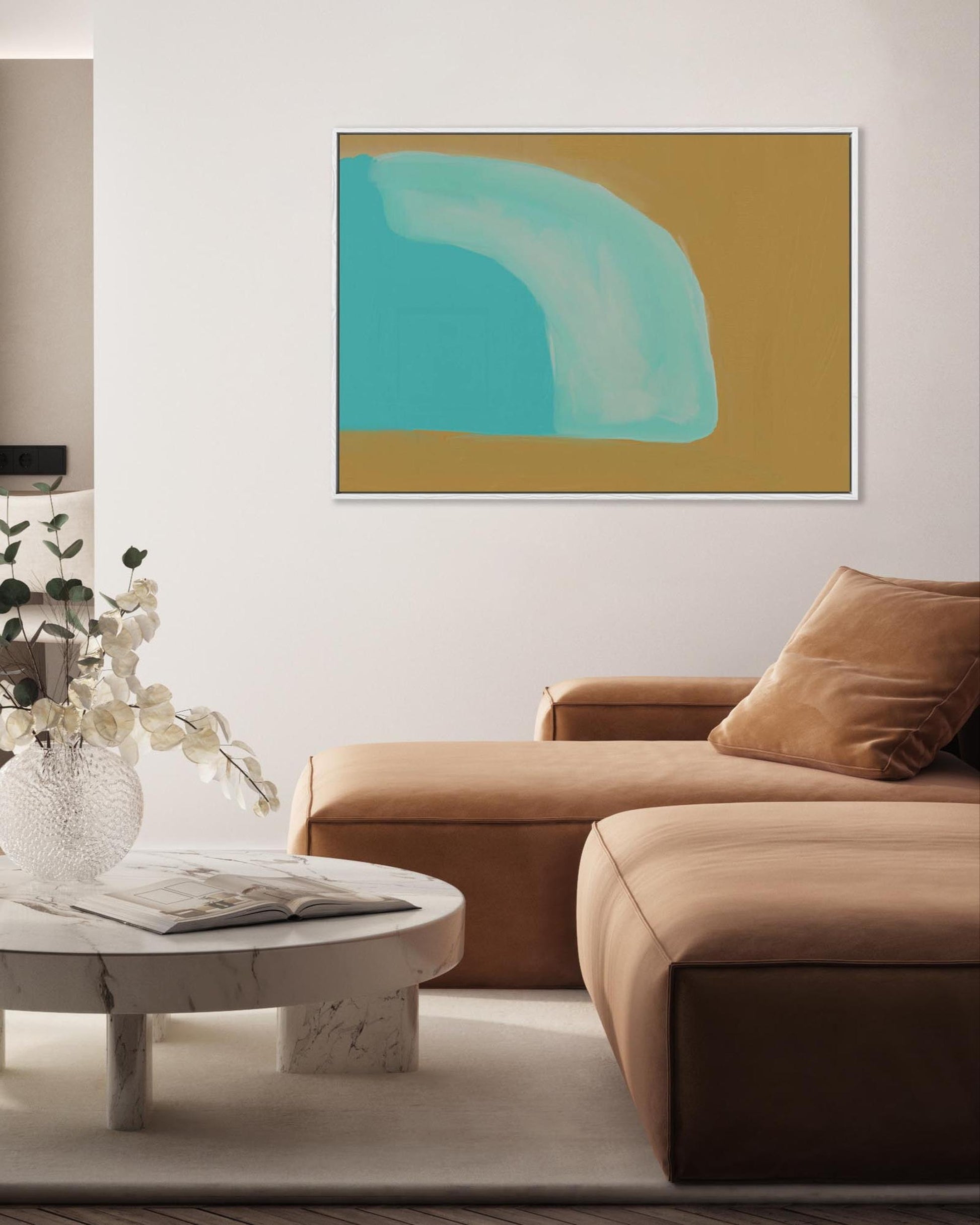 Modern living room with a brown sofa, round coffee table, and abstract art on the wall.