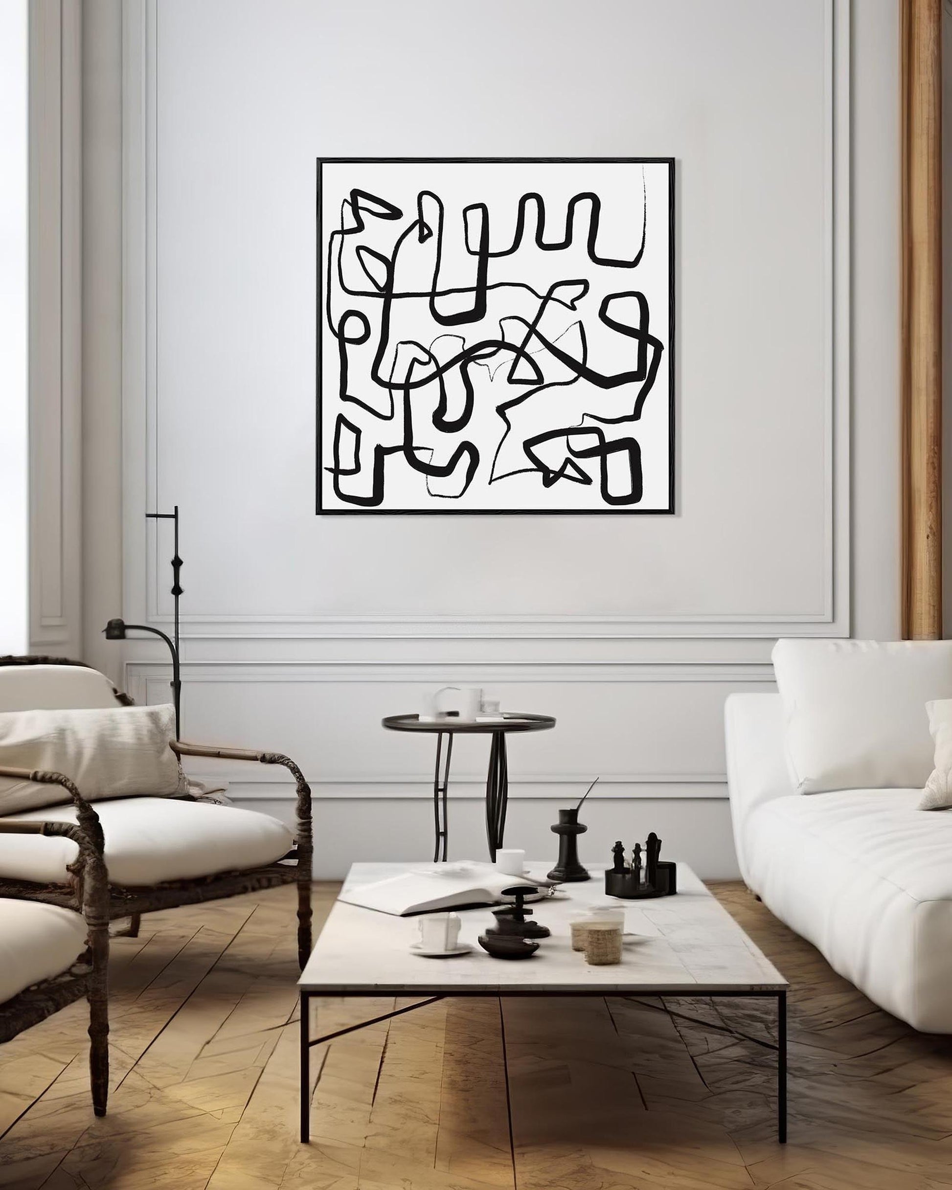 Modern living room with abstract black and white artwork on the wall.