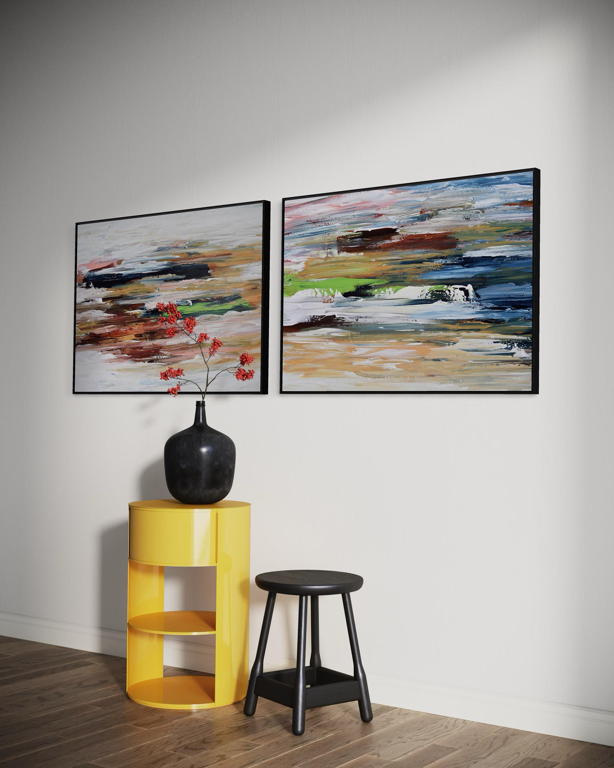 Two abstract paintings on a wall with a yellow side table and black stool below.