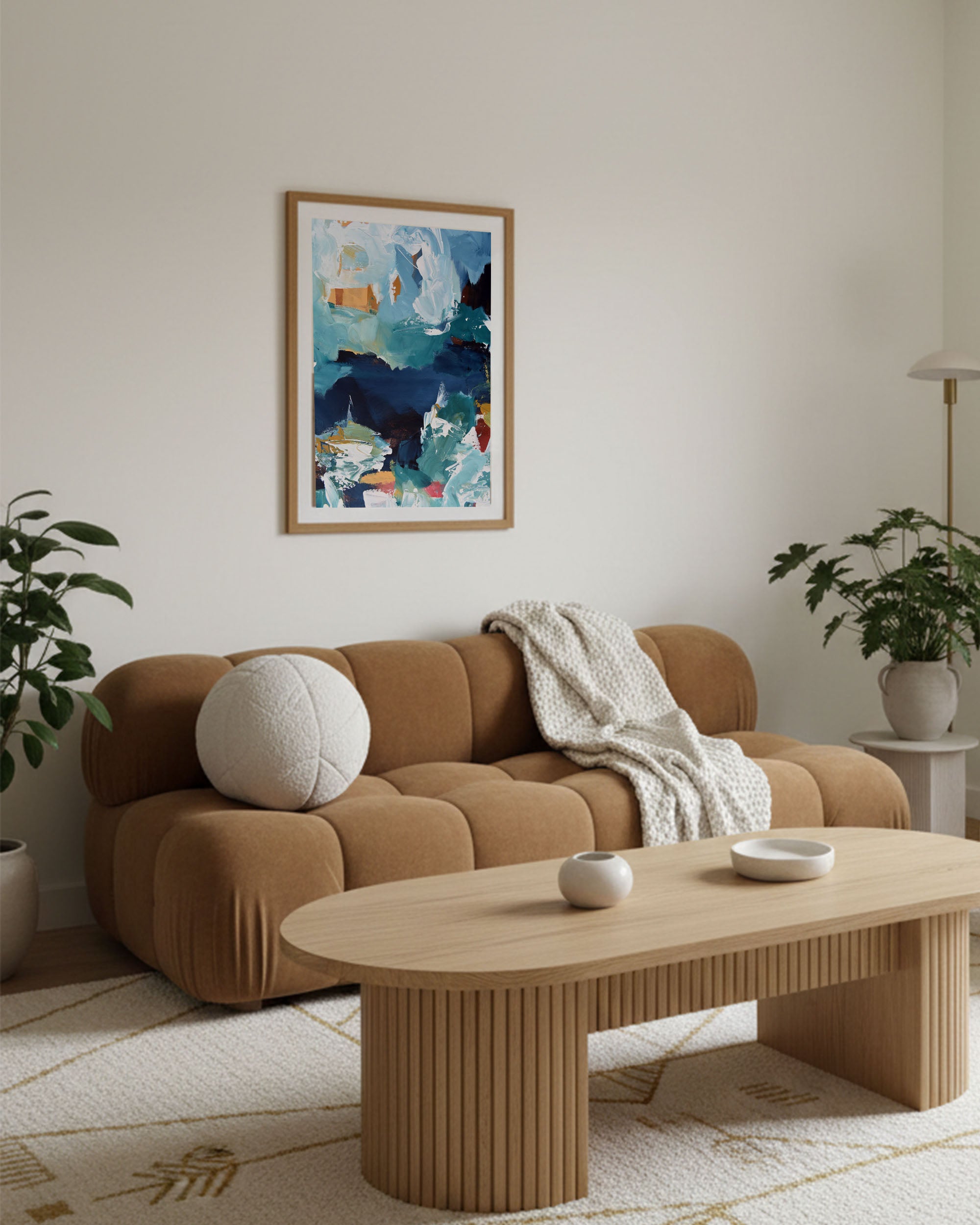 Modern living room with a brown sofa, wooden coffee table, and abstract art on the wall.