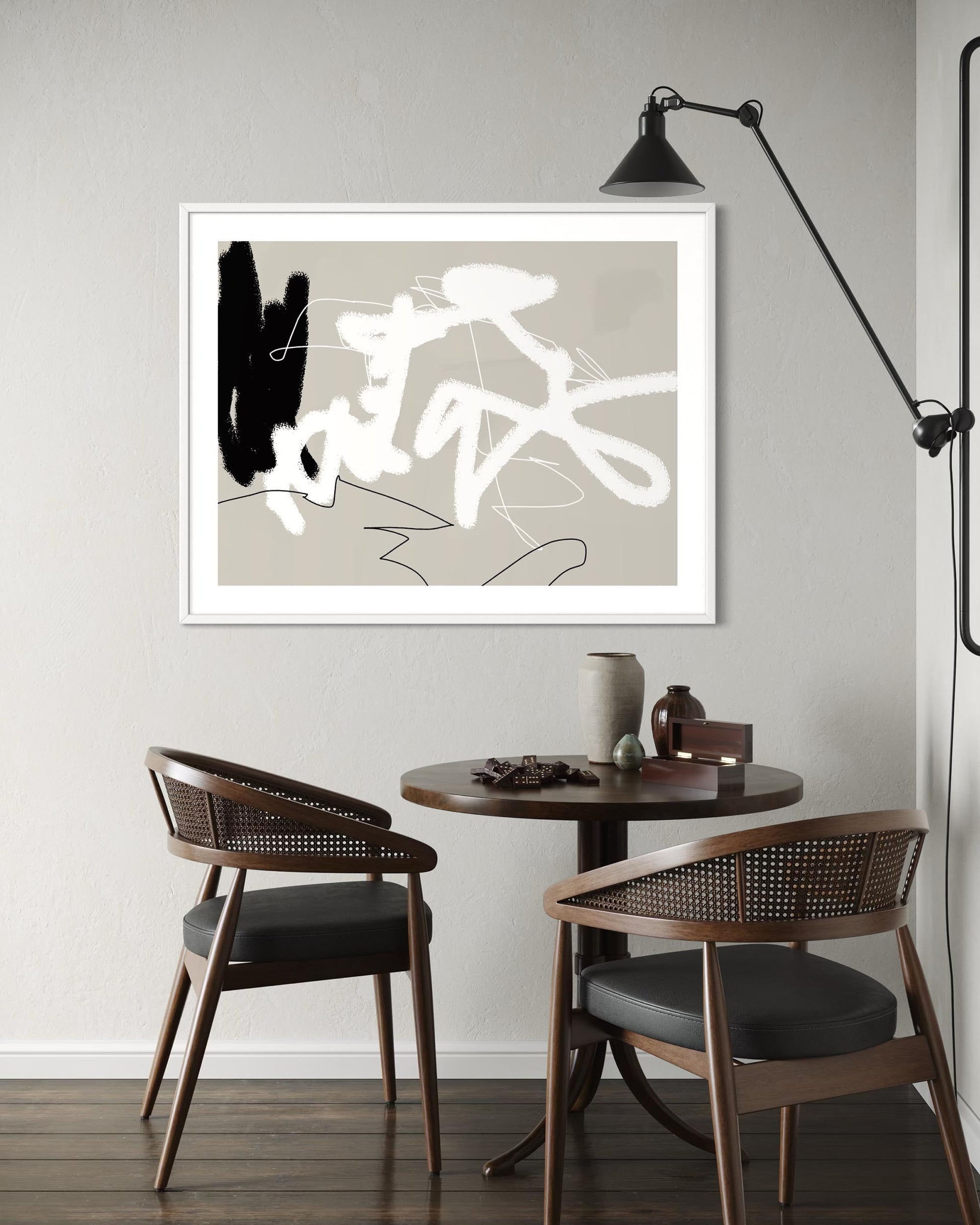Modern interior with abstract art, round table, and chairs.