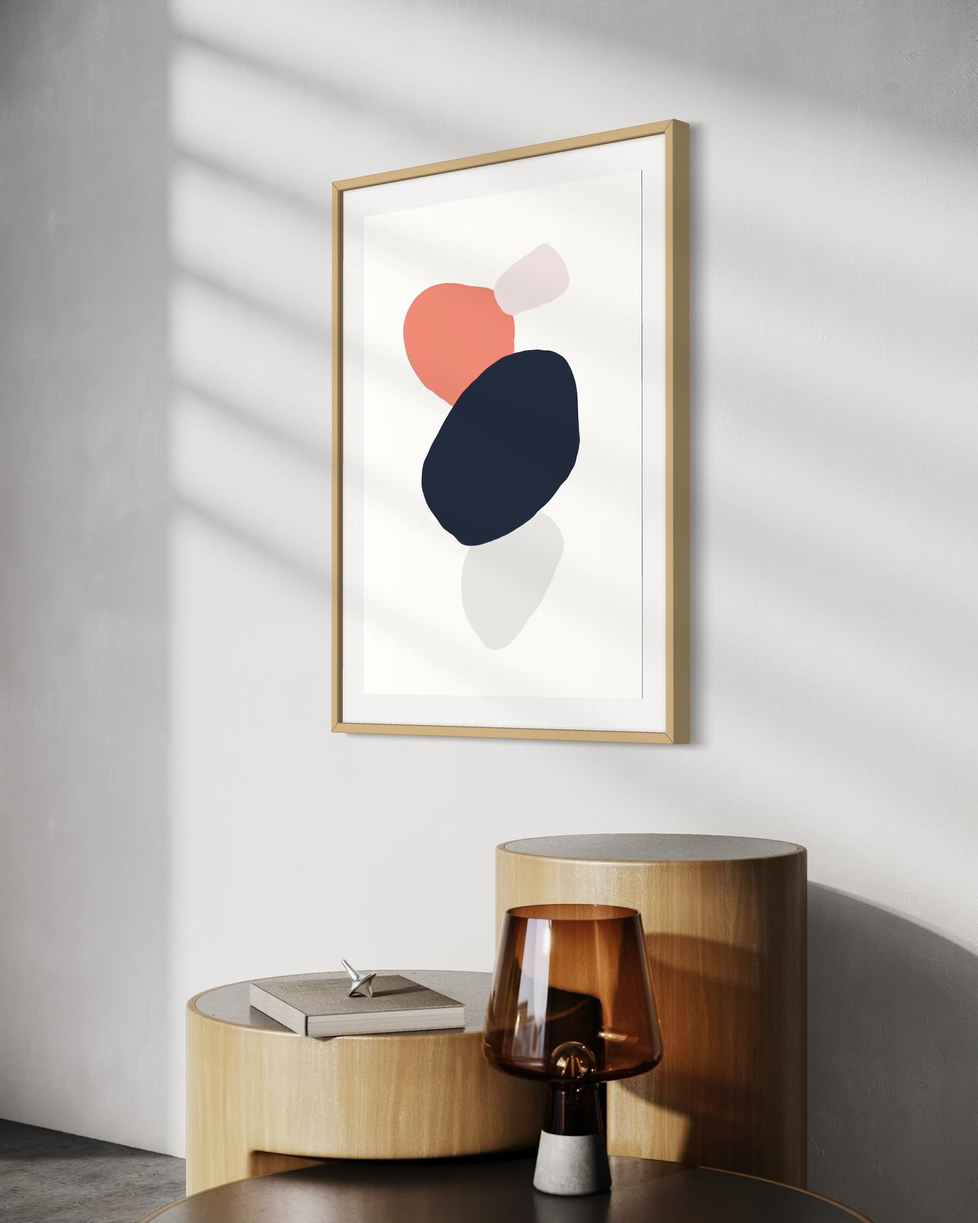 Framed abstract art piece on a wall with a side table below