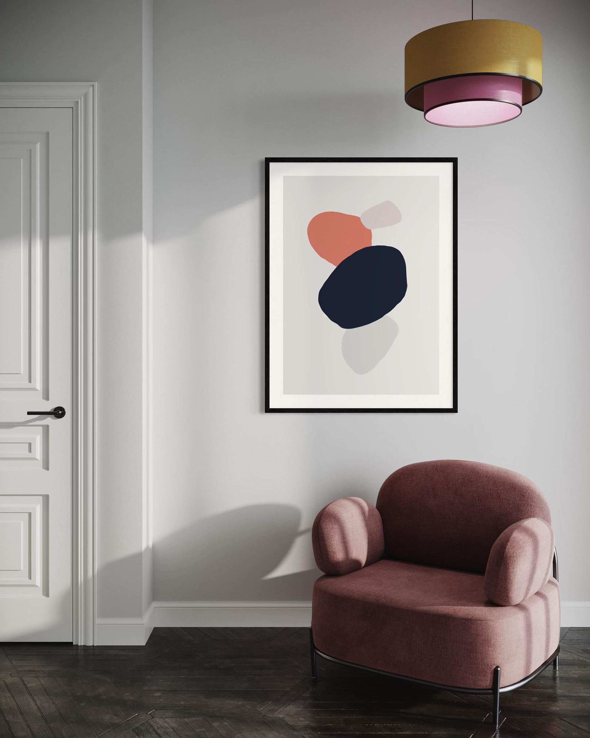 Modern interior with a pink armchair and abstract art on the wall.