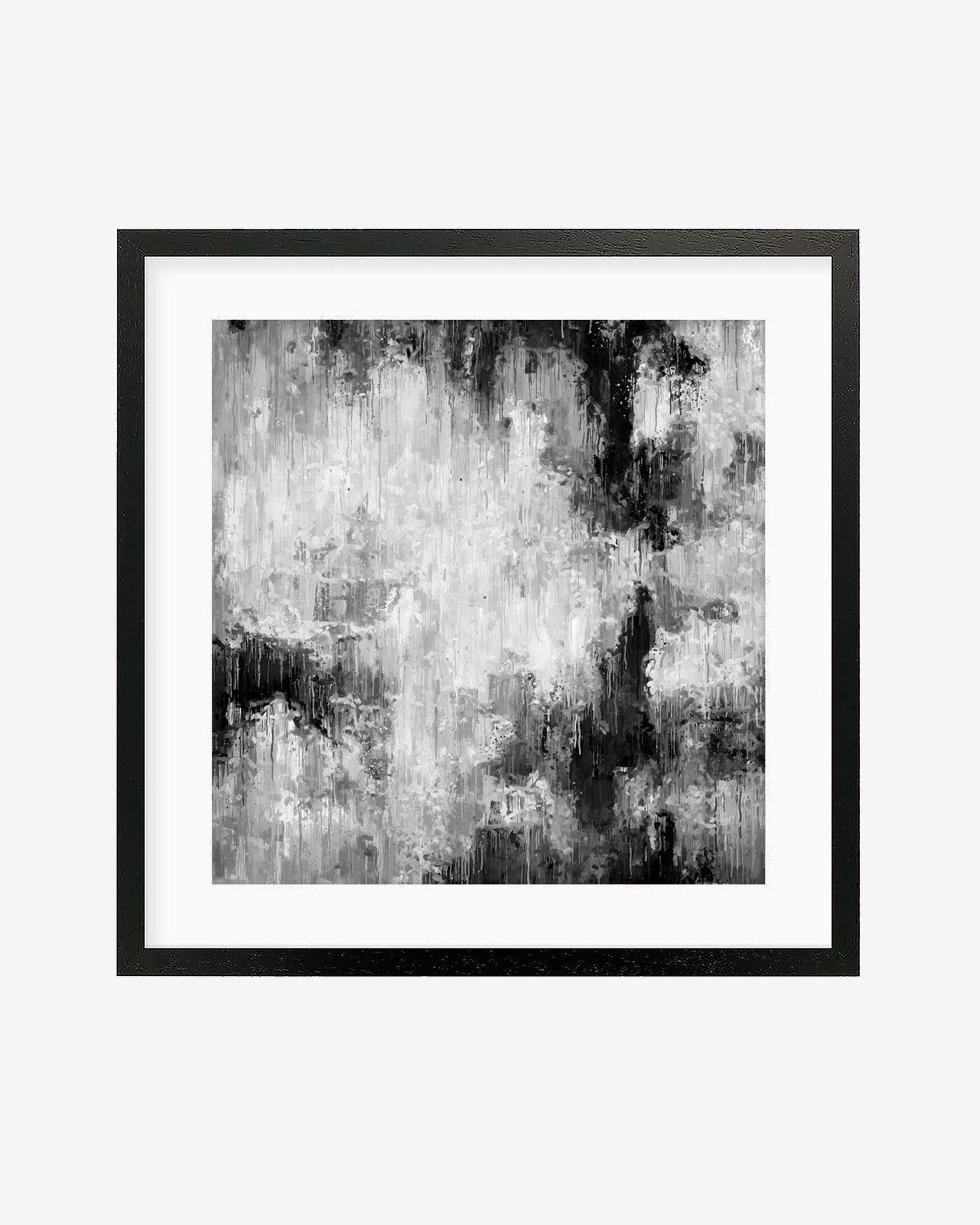 A framed monochrome abstract art print with layers of black and grey over a white background, encased in a black frame.