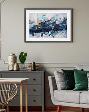 Living room with a gray sofa, decorative pillows, a small table with vases, and a framed abstract painting on the wall.
