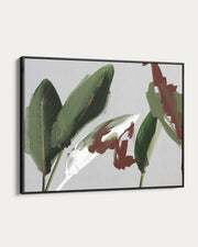 Framed artwork of green leaves on a light gray background