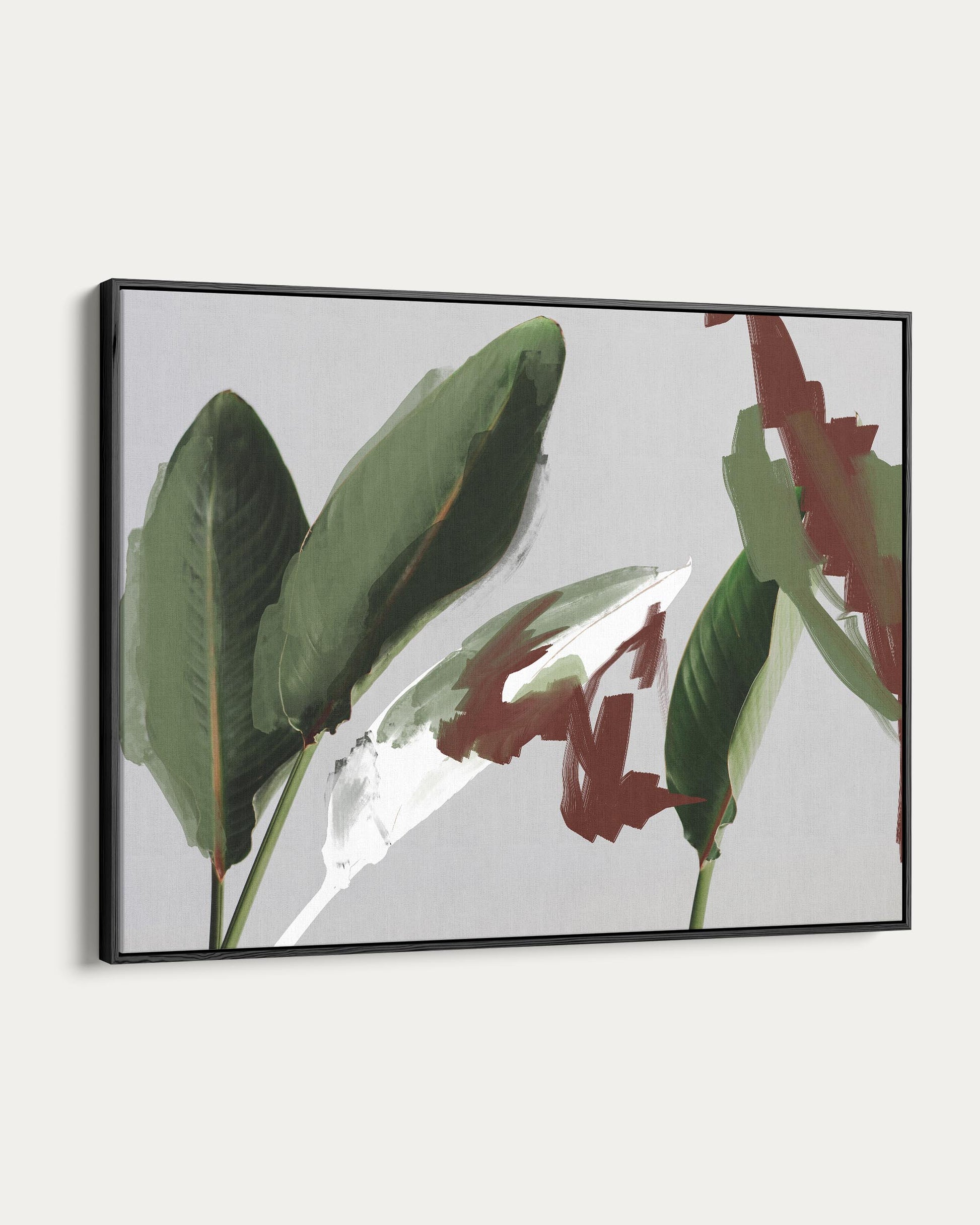 Framed artwork of green leaves on a light gray background