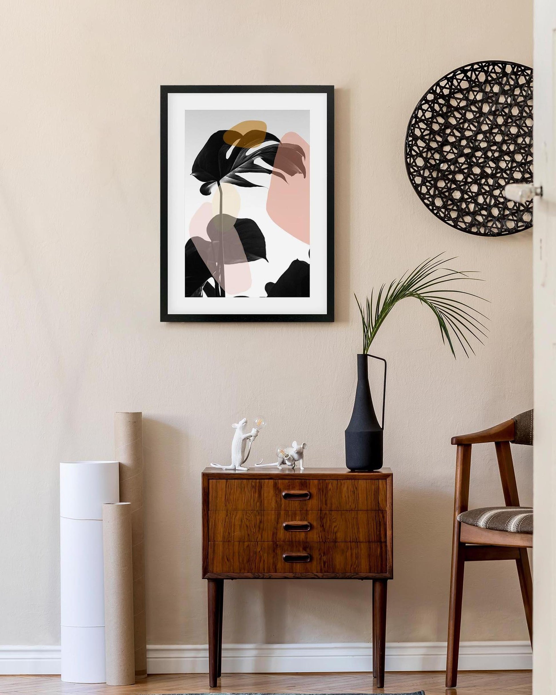 Modern interior with abstract art, wooden cabinet, and decorative items.