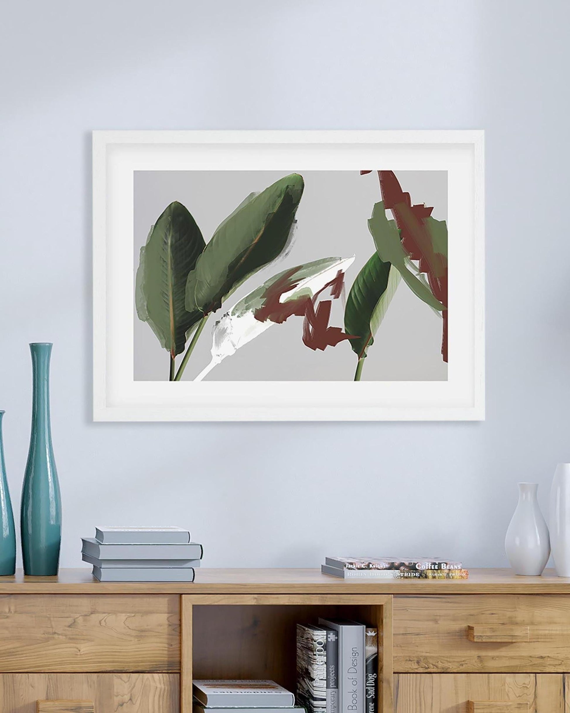 Framed abstract art piece on a wall above a wooden cabinet with decorative items.