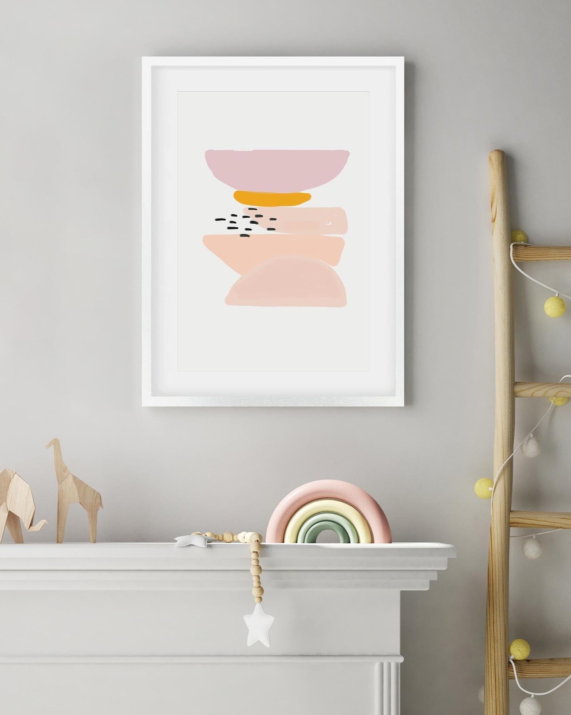 Framed abstract art print on a gray wall above a white fireplace with decorative items.