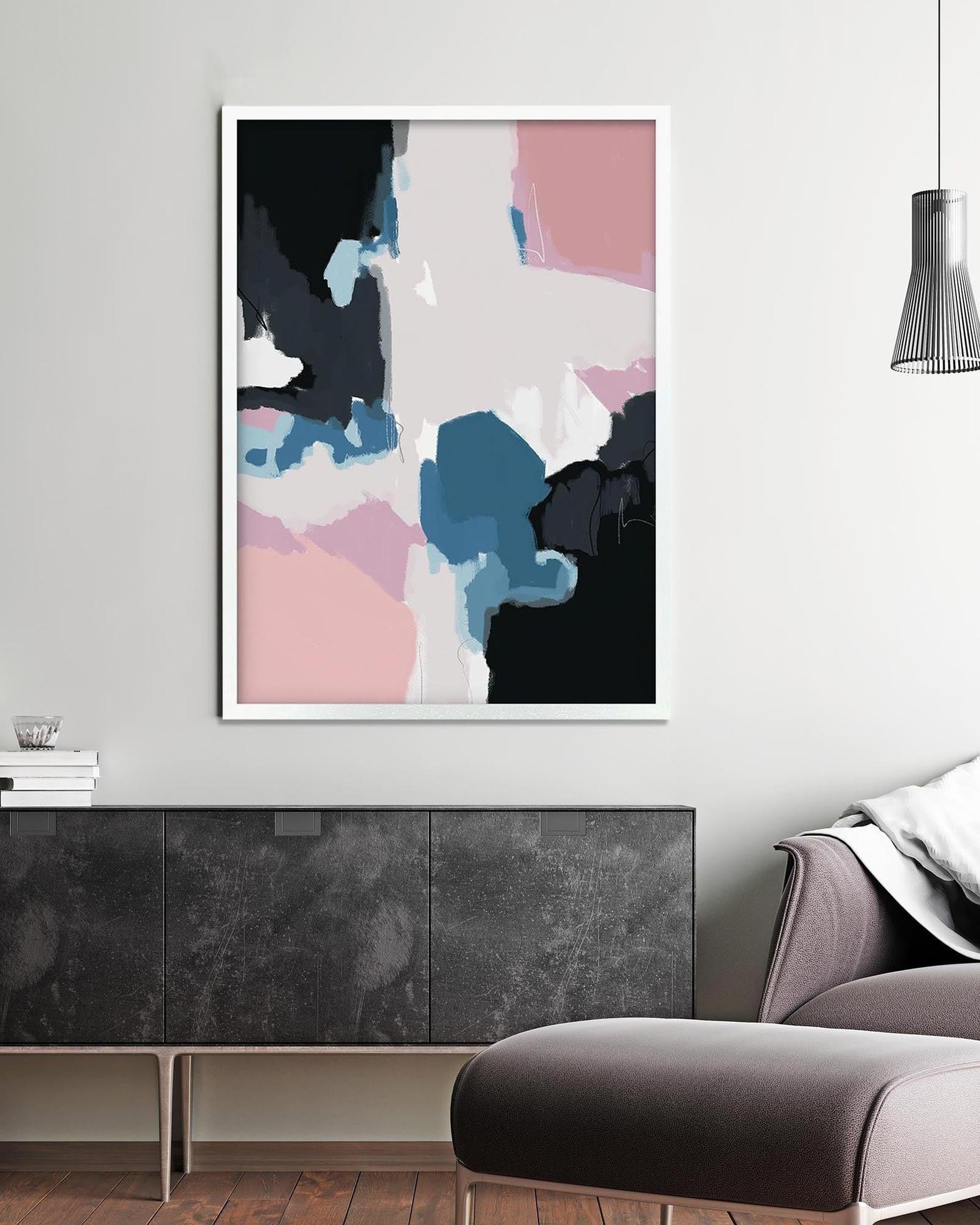 Abstract art print on a wall above a sofa and sideboard in a living room.