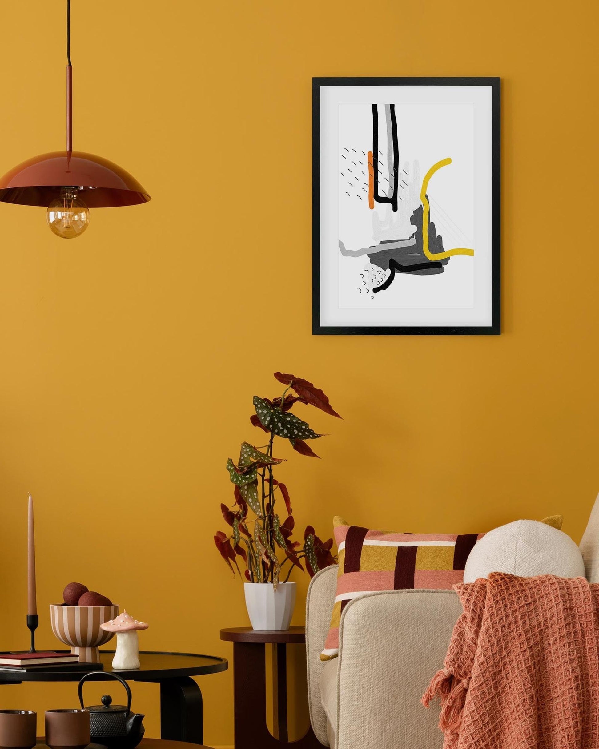 framed print on orange wall in living room