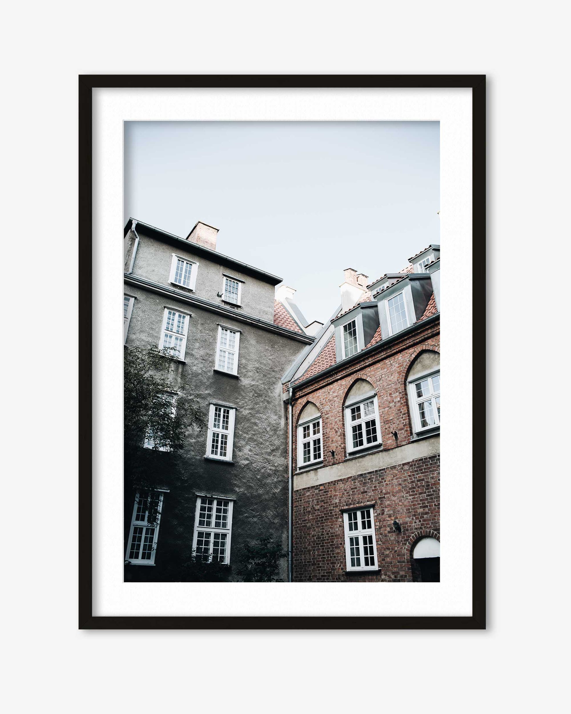 Framed photograph of two buildings with a black frame on a white background