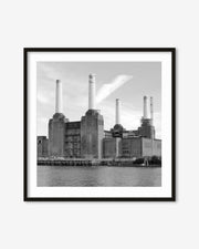 Framed black and white photograph of a industrial building with smokestacks by a body of water.