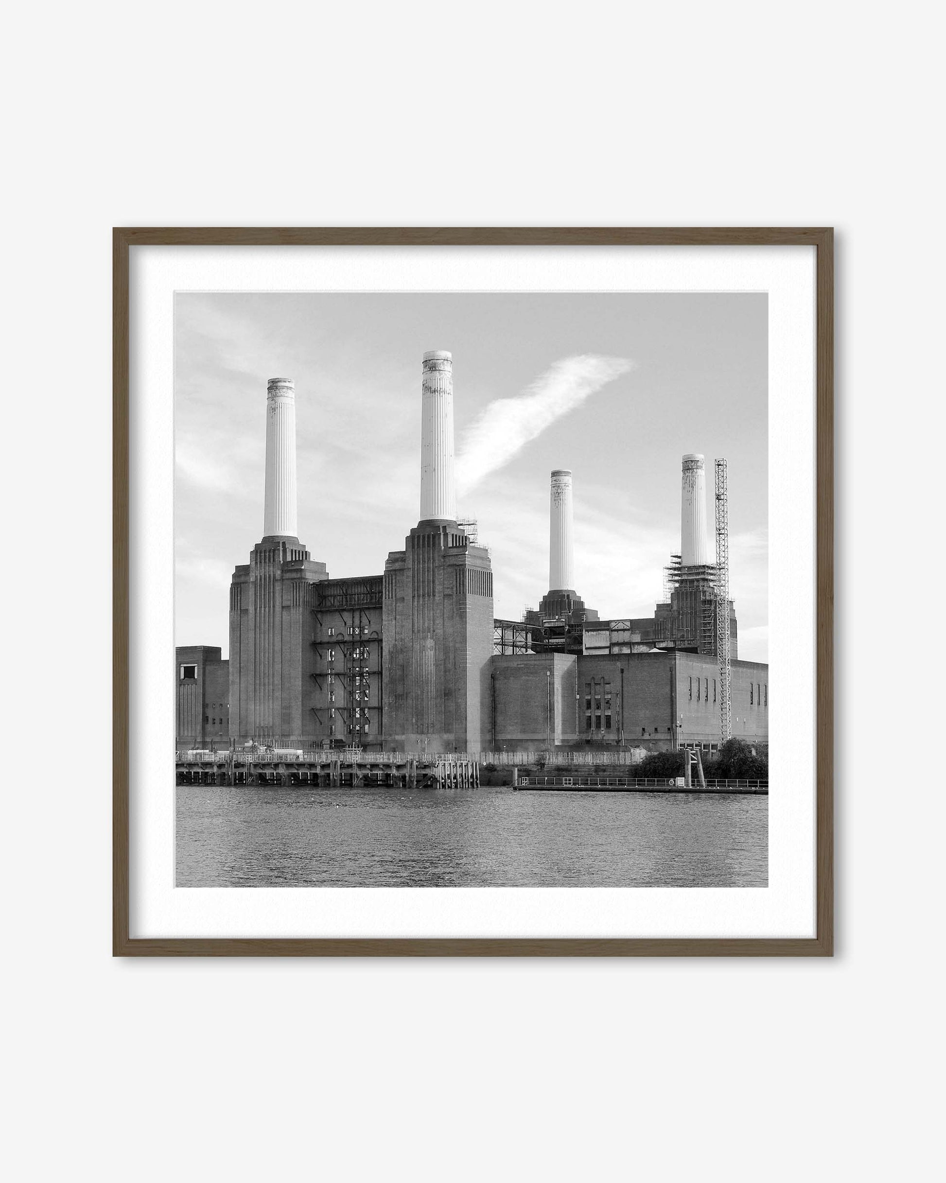 Framed black and white photograph of a industrial building with smokestacks by a body of water.