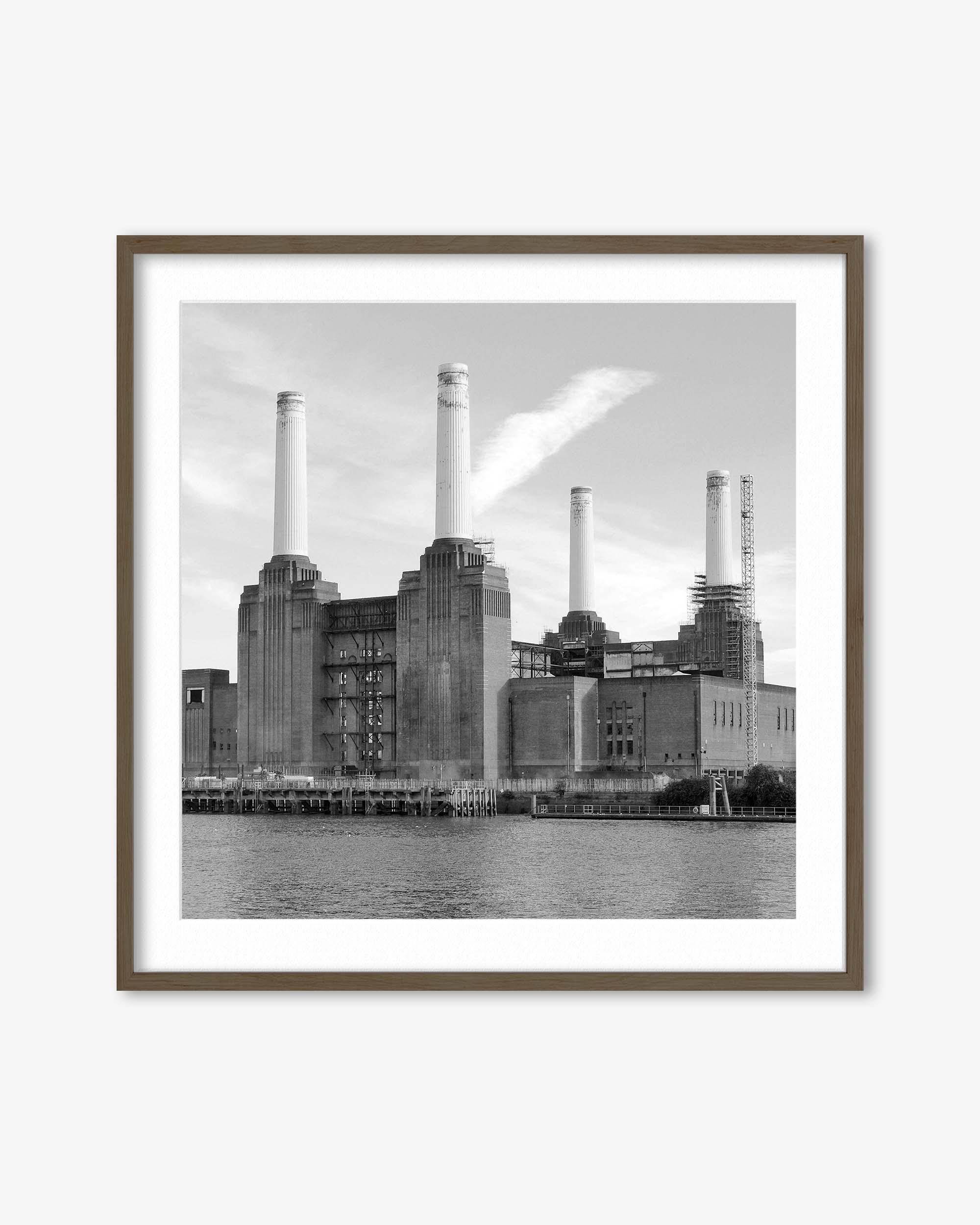 Framed black and white photograph of a industrial building with smokestacks by a body of water.