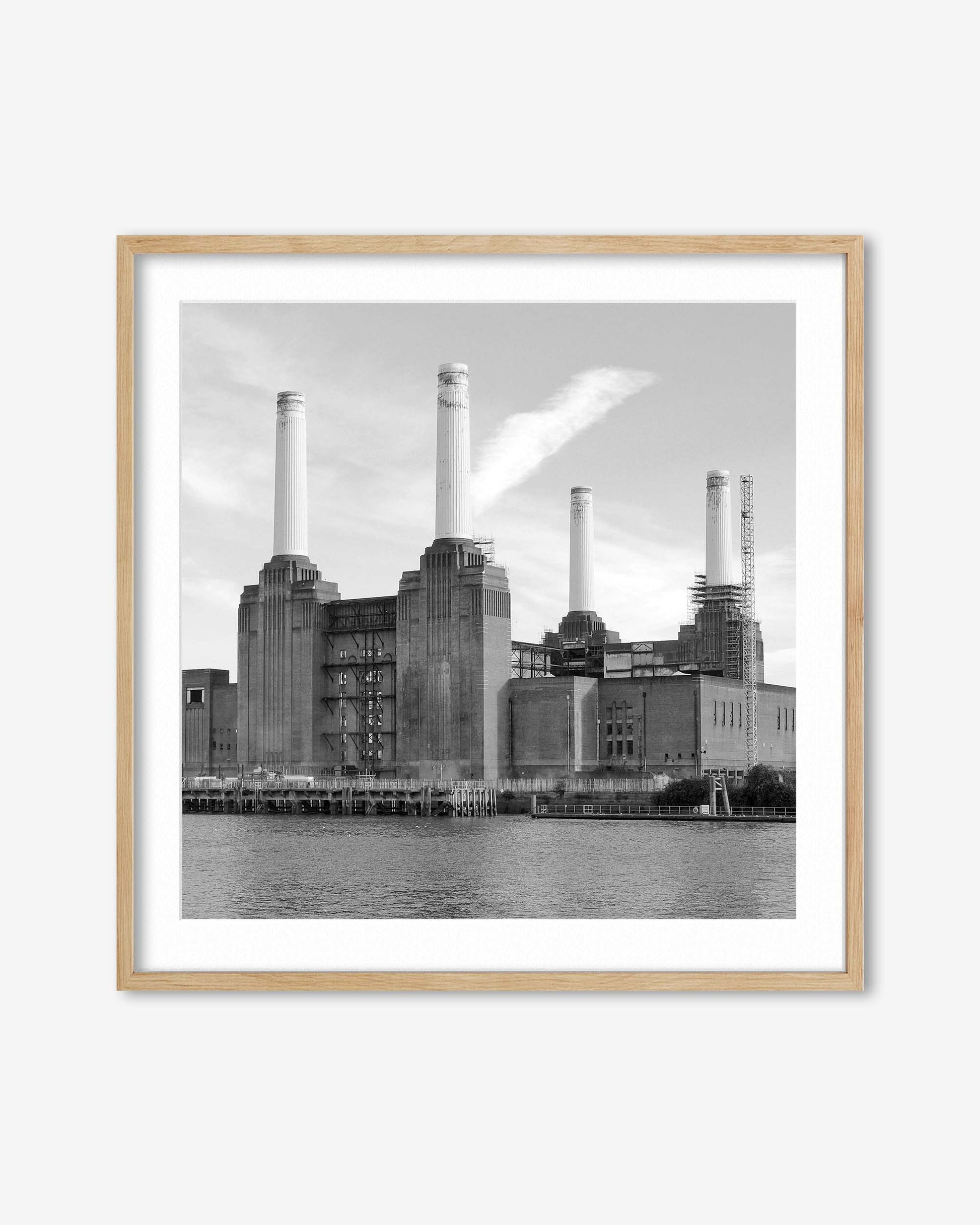 Framed black and white photograph of a industrial building with chimneys.