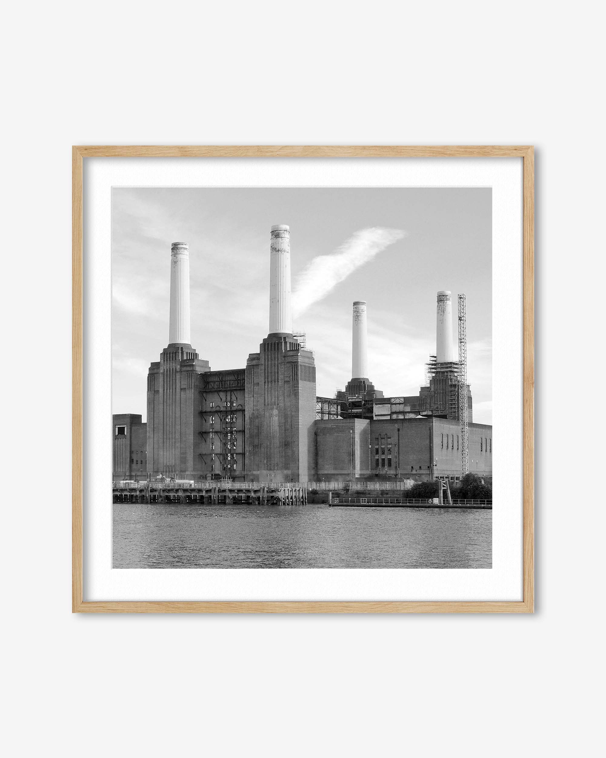 Framed black and white photograph of a industrial building with chimneys.