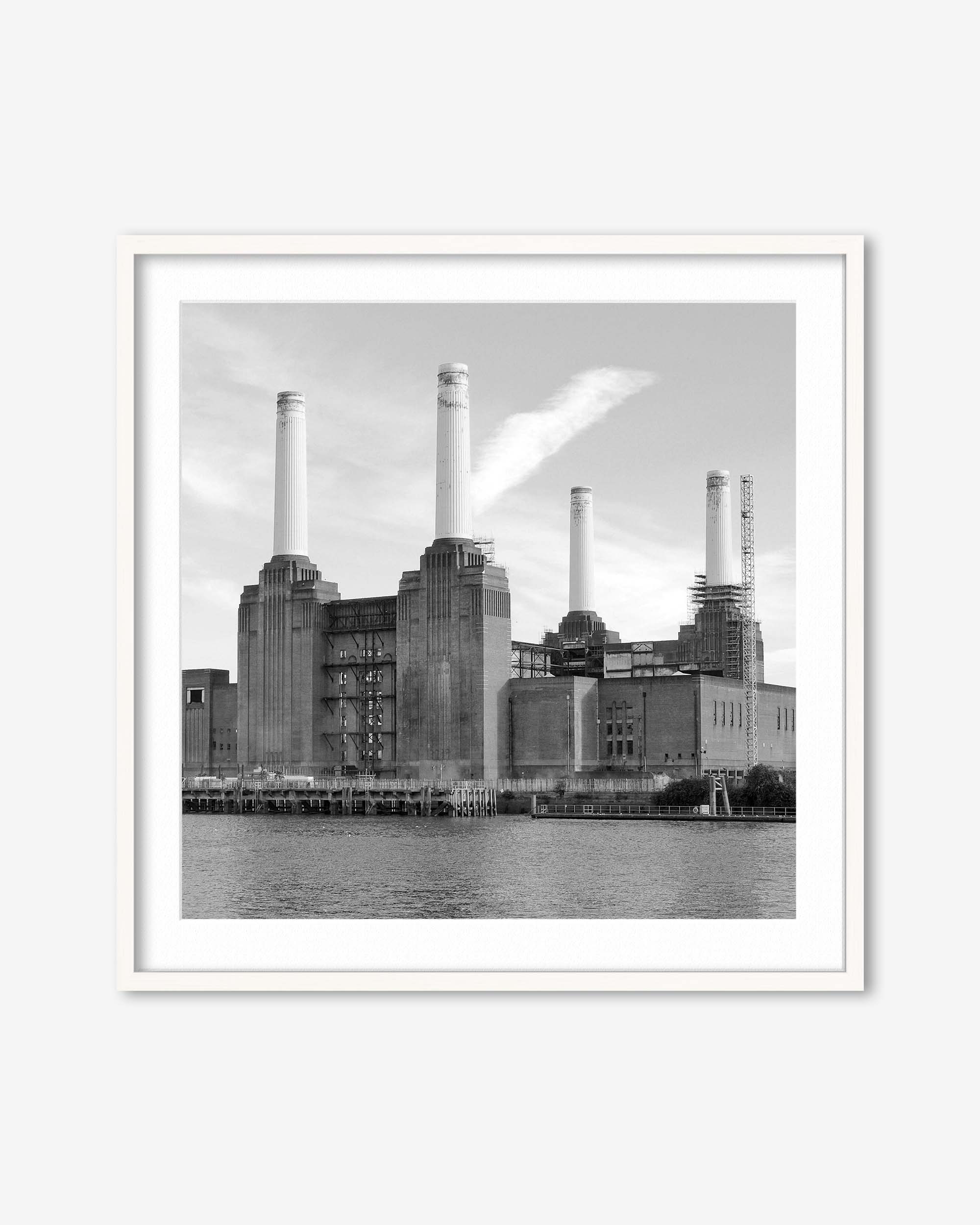 Framed black and white photograph of a industrial building with smokestacks by a body of water.