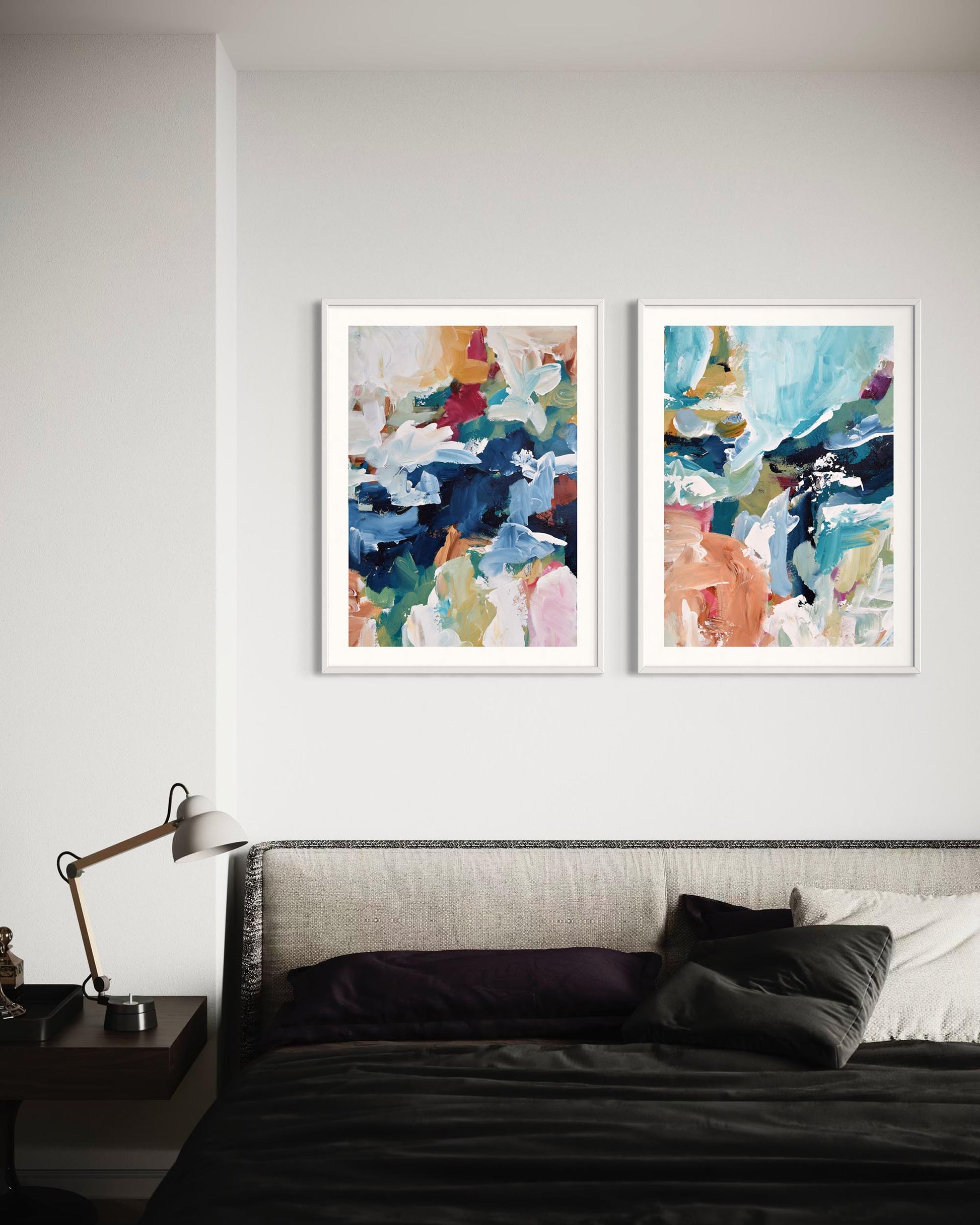 Two abstract art prints on a wall above a bed with a lamp and nightstand.