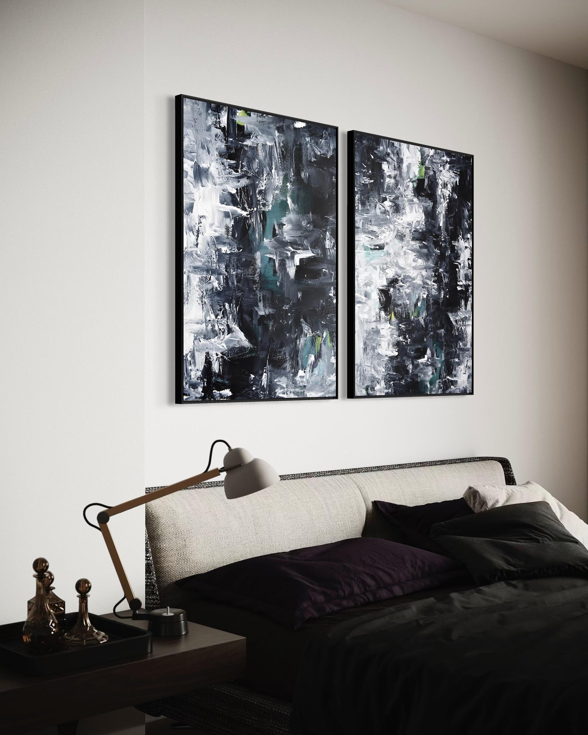 Two abstract paintings on a wall above a bed in a bedroom.