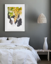 Modern bedroom with a bed, framed artwork, pendant light, and vase.
