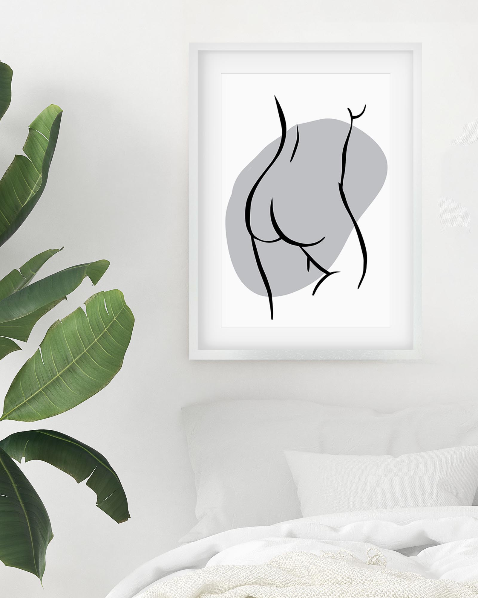 Framed abstract art print on a wall with green leaves in the corner.