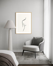 Modern interior with a chair, lamp, and abstract art on the wall.