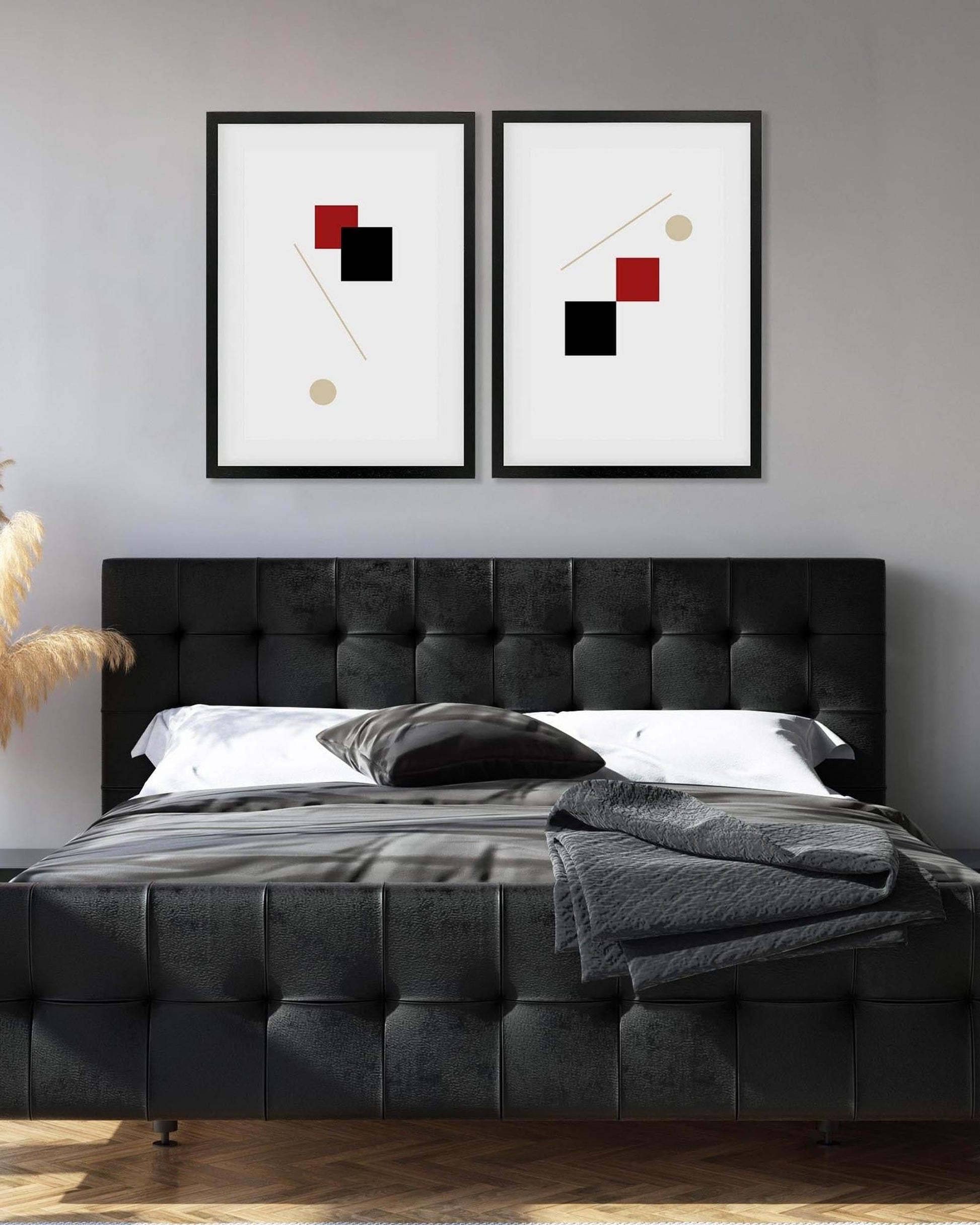 Modern bedroom with a black upholstered bed and abstract art on the wall.