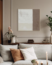 Living room with a sofa, decorative pillows, and a wall art piece.