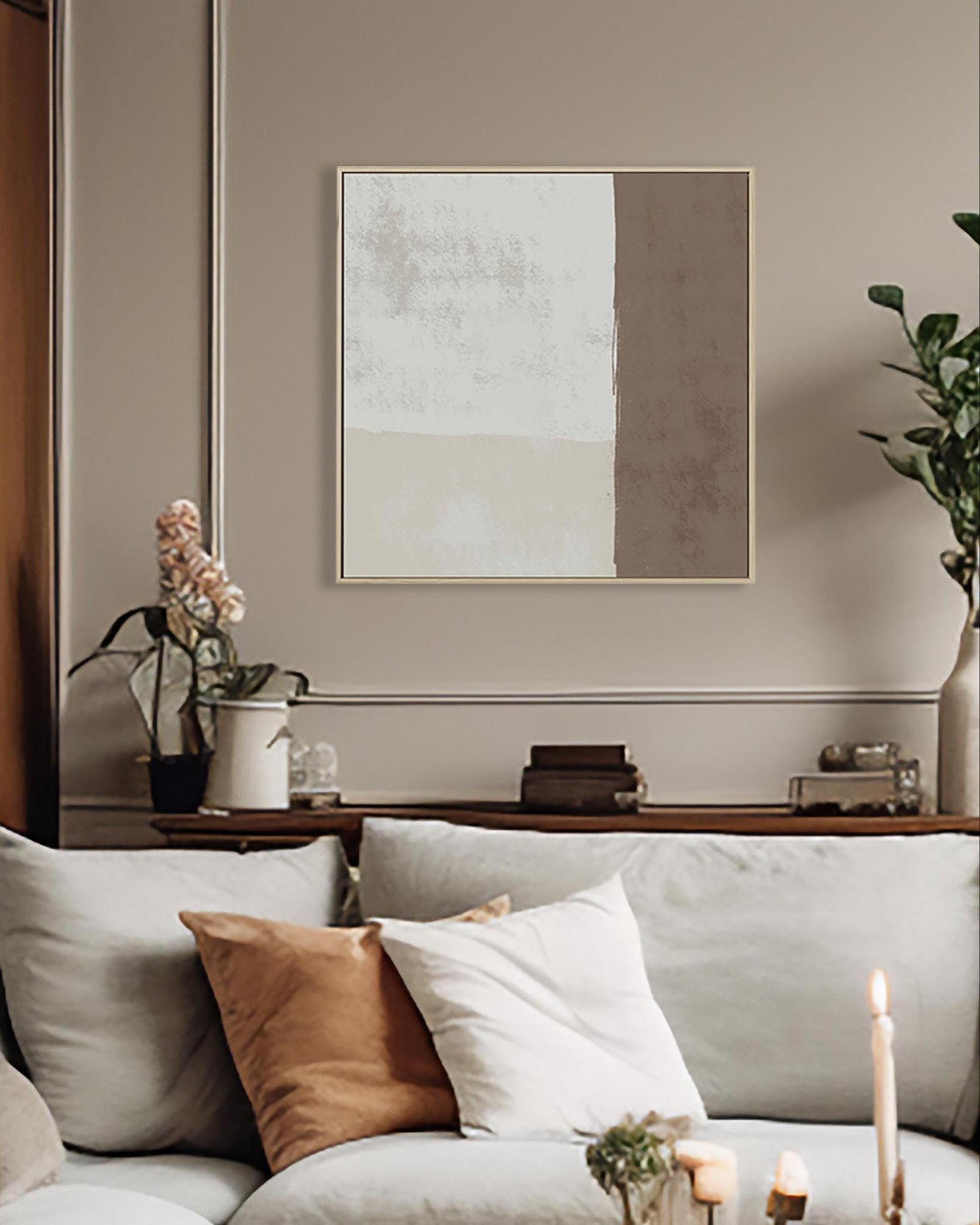Living room with a sofa, decorative pillows, and a wall art piece.