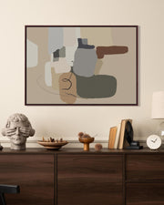 Abstract art piece on a wall above a wooden console table with decorative items.