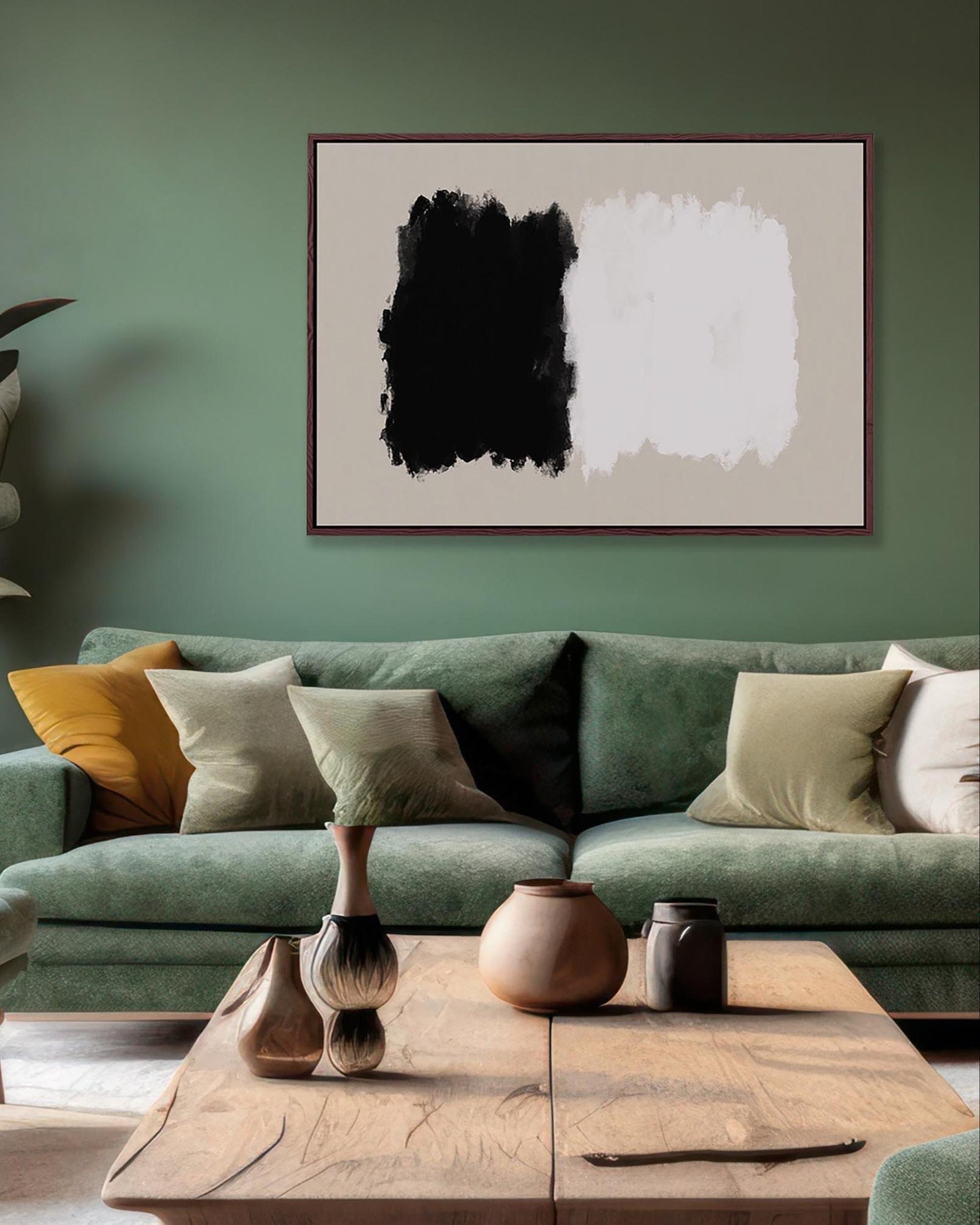 Living room with a green sofa, abstract art on the wall, and decorative items on a coffee table.
