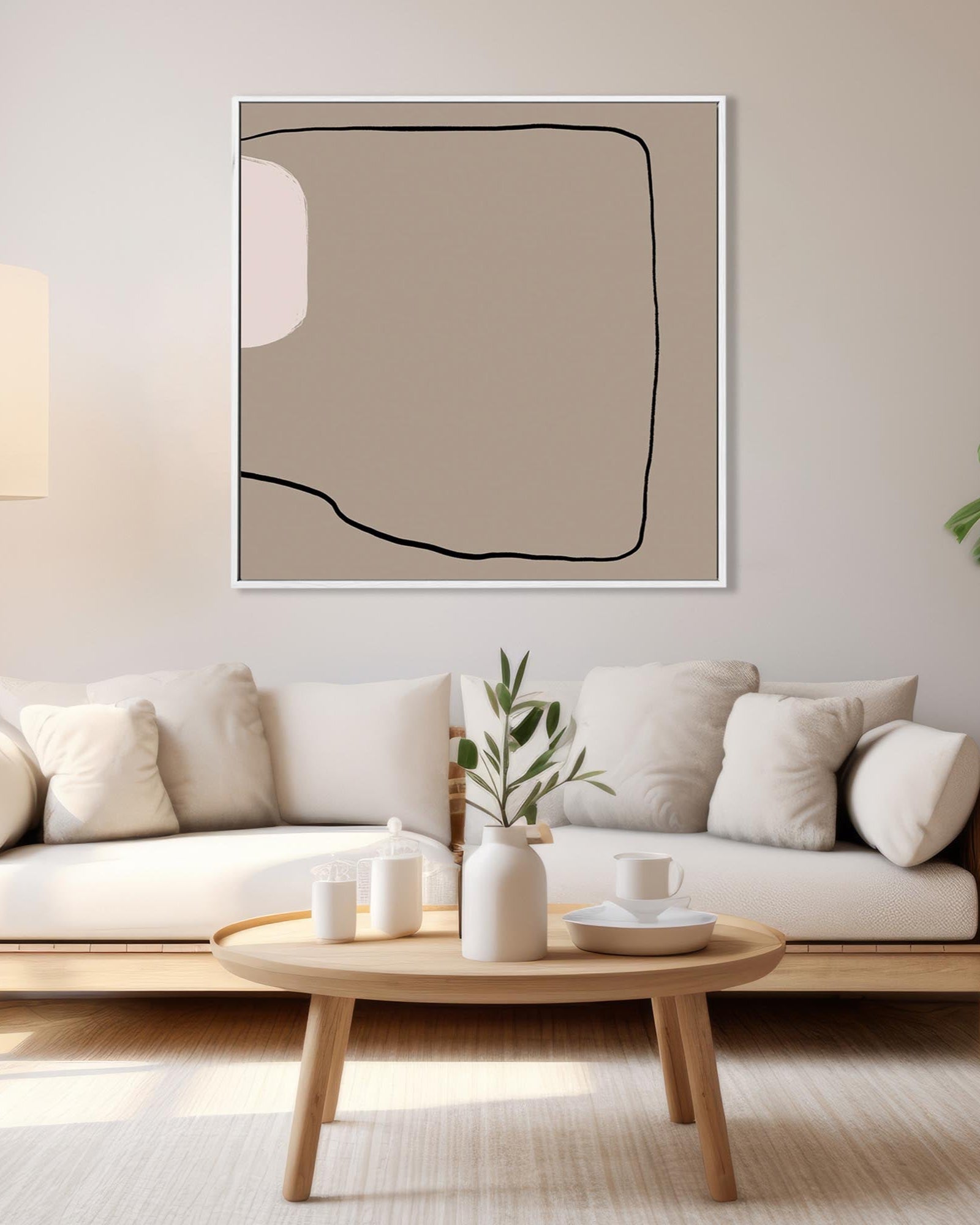 Modern living room with a white sofa, wooden coffee table, and abstract art on the wall.