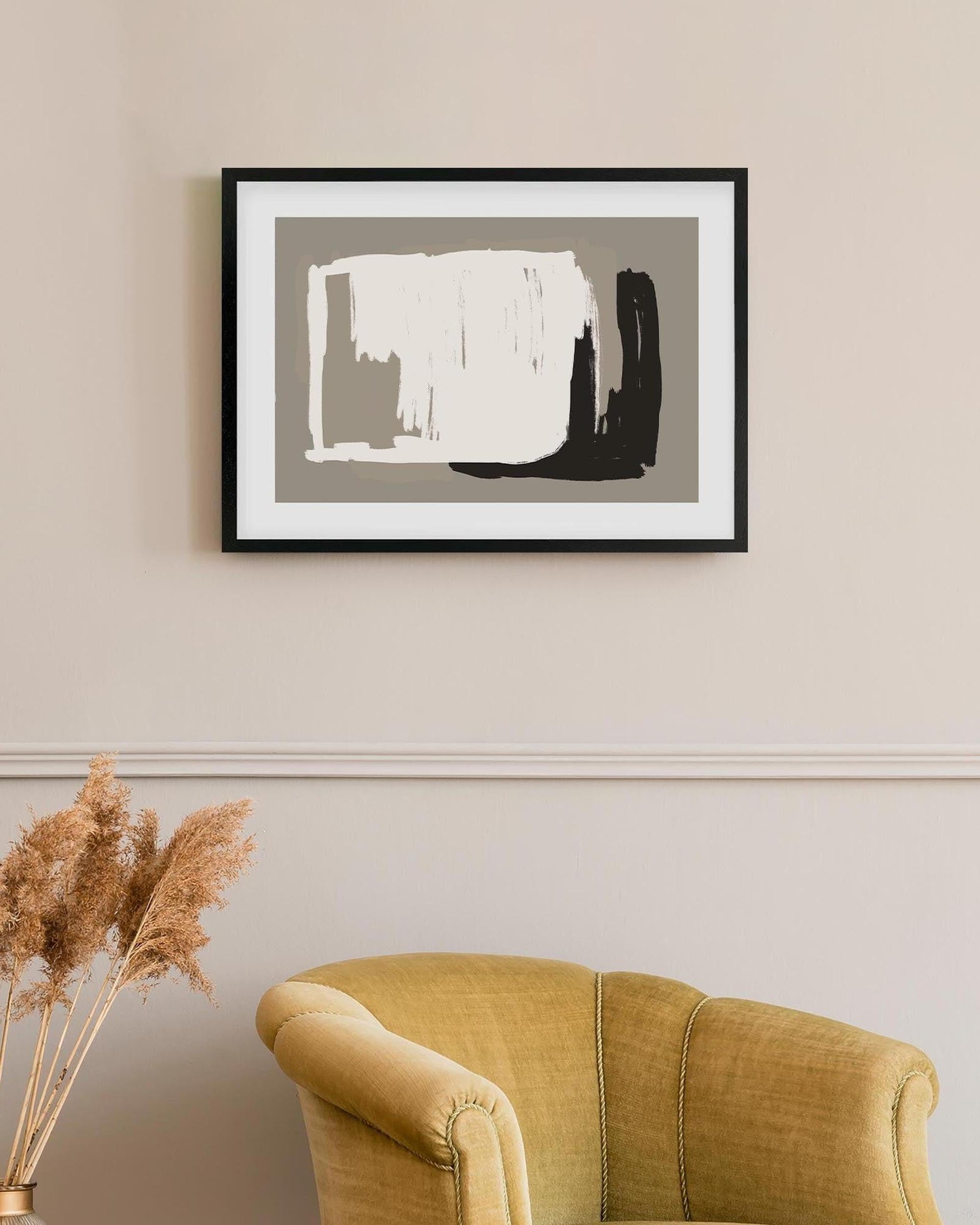 Abstract art print on a wall above a yellow armchair with decorative elements.
