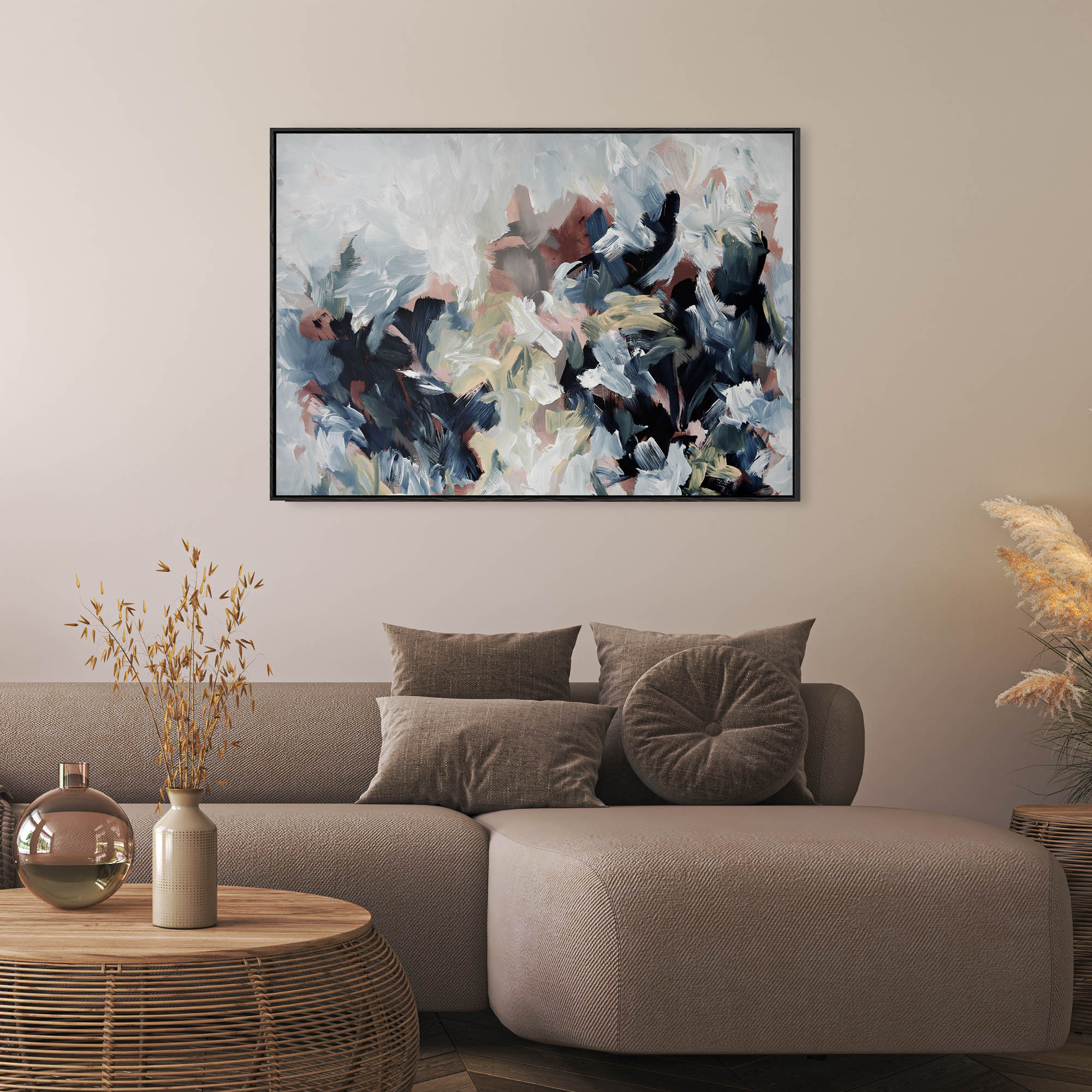 abstract painting on canvas in modern stylish living room with brown sofa, vase and flowers on rattan sustainable coffee table.
