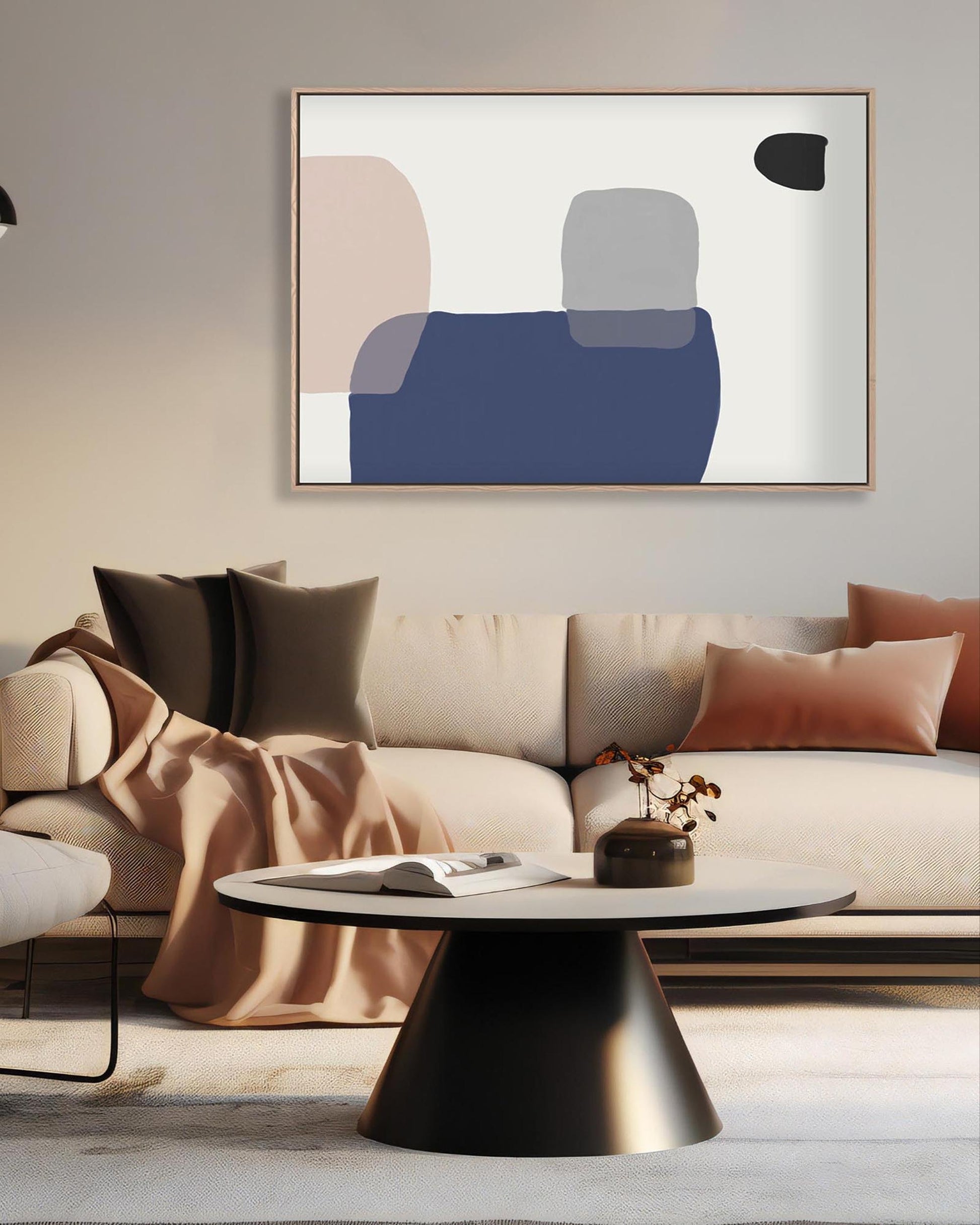 Modern living room with a beige sectional sofa, abstract art on the wall, and a round coffee table.