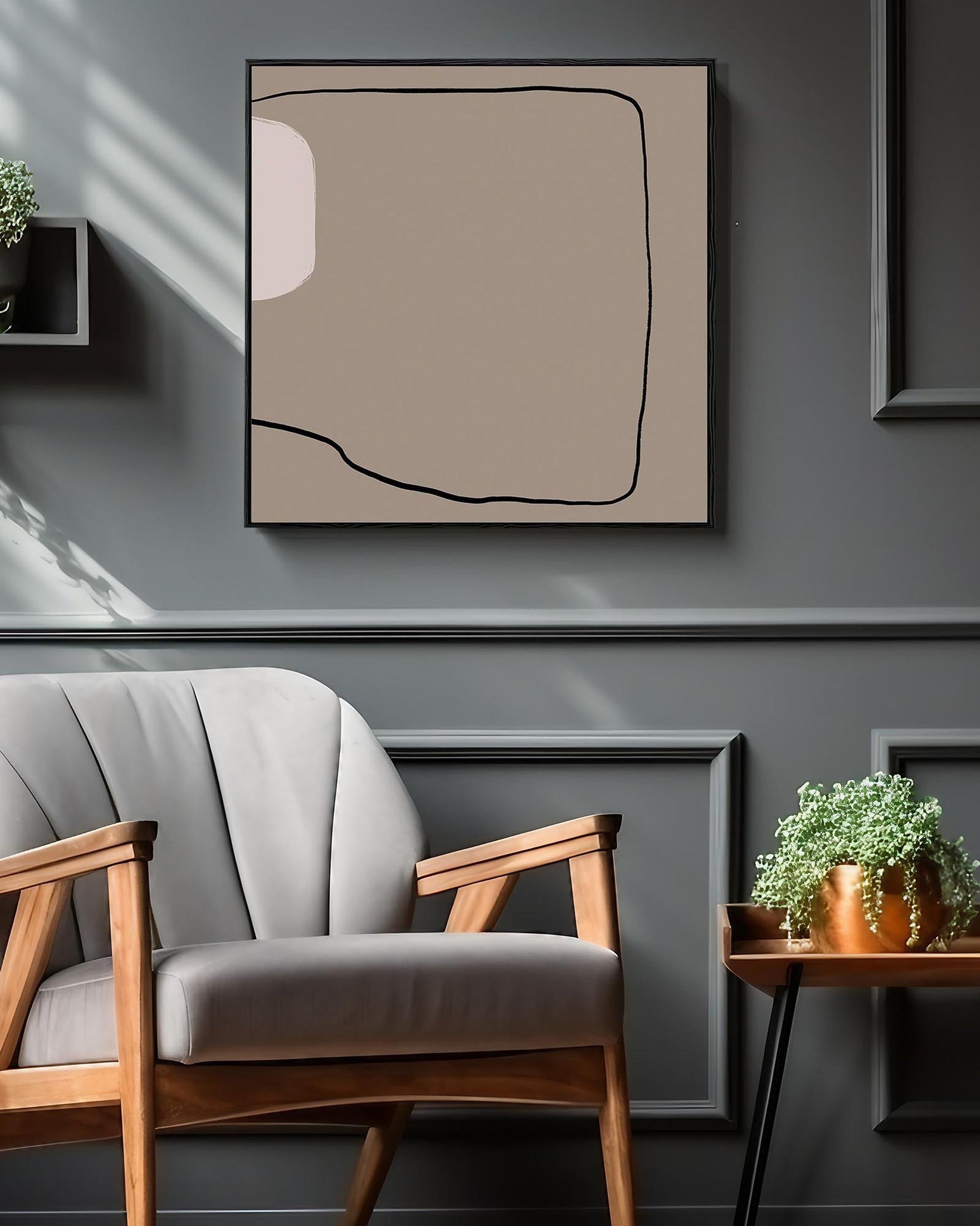 Modern interior with a gray armchair, abstract art, and plants on a gray wall.