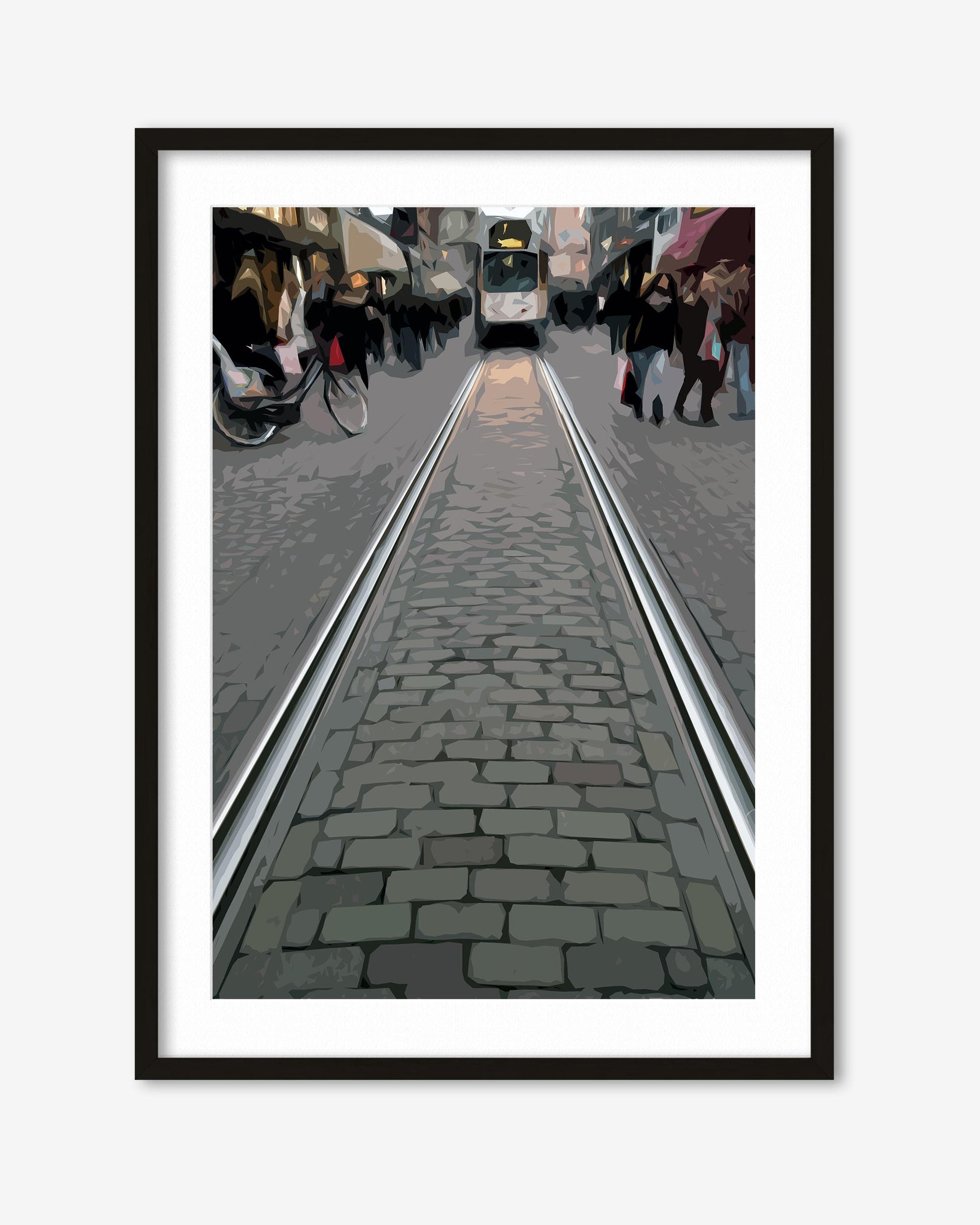 Framed photograph of a street scene with tram tracks and people walking.