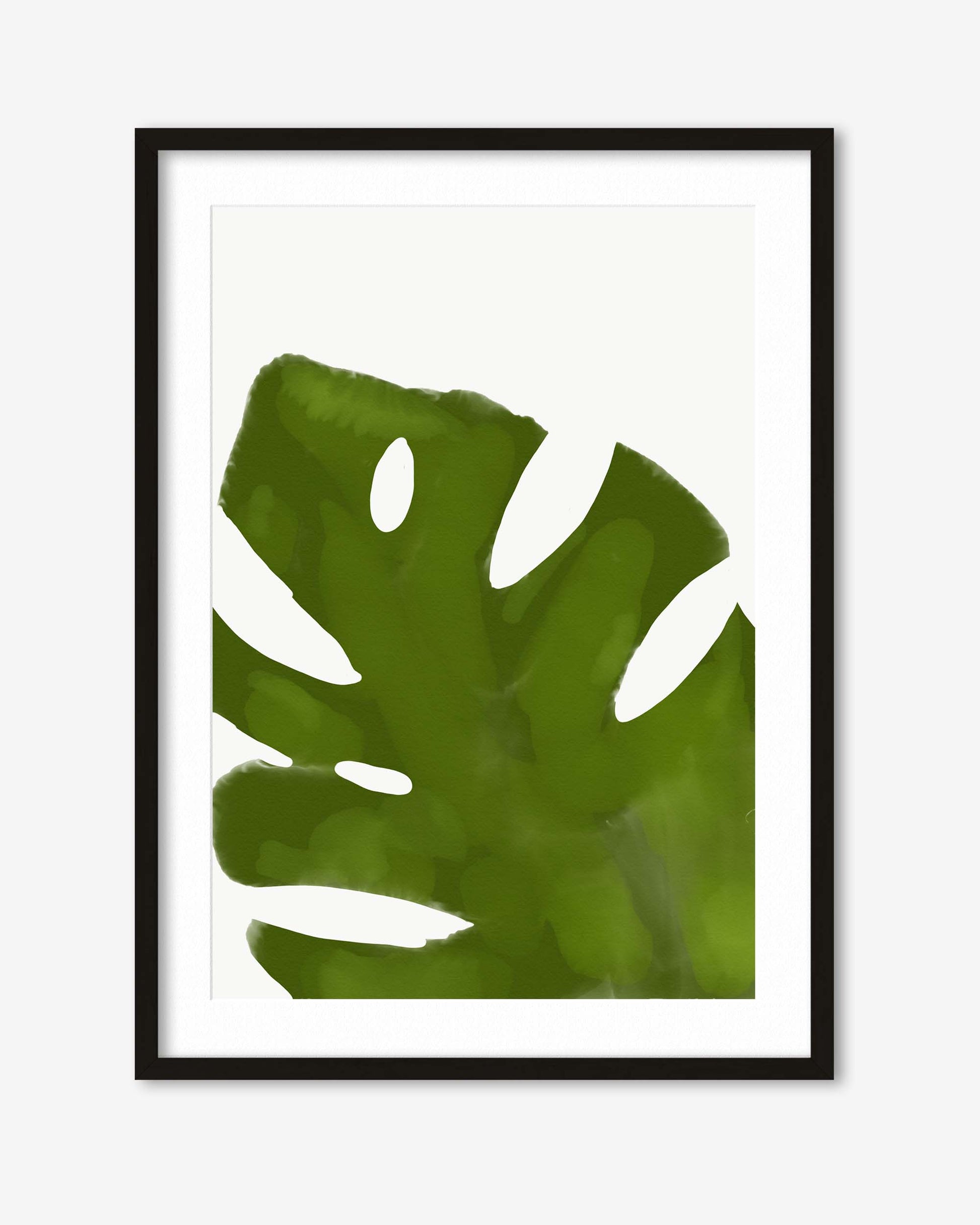 Framed artwork of a green leaf on a white background