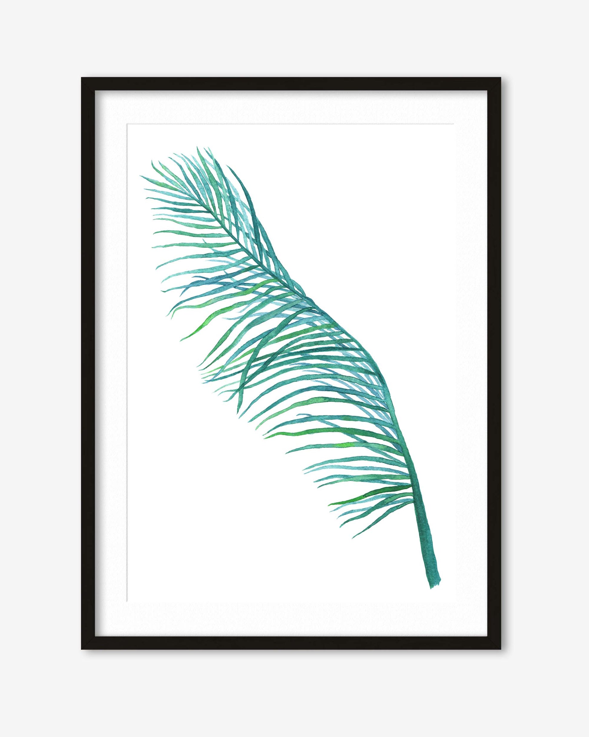Framed artwork of a green palm leaf on a white background
