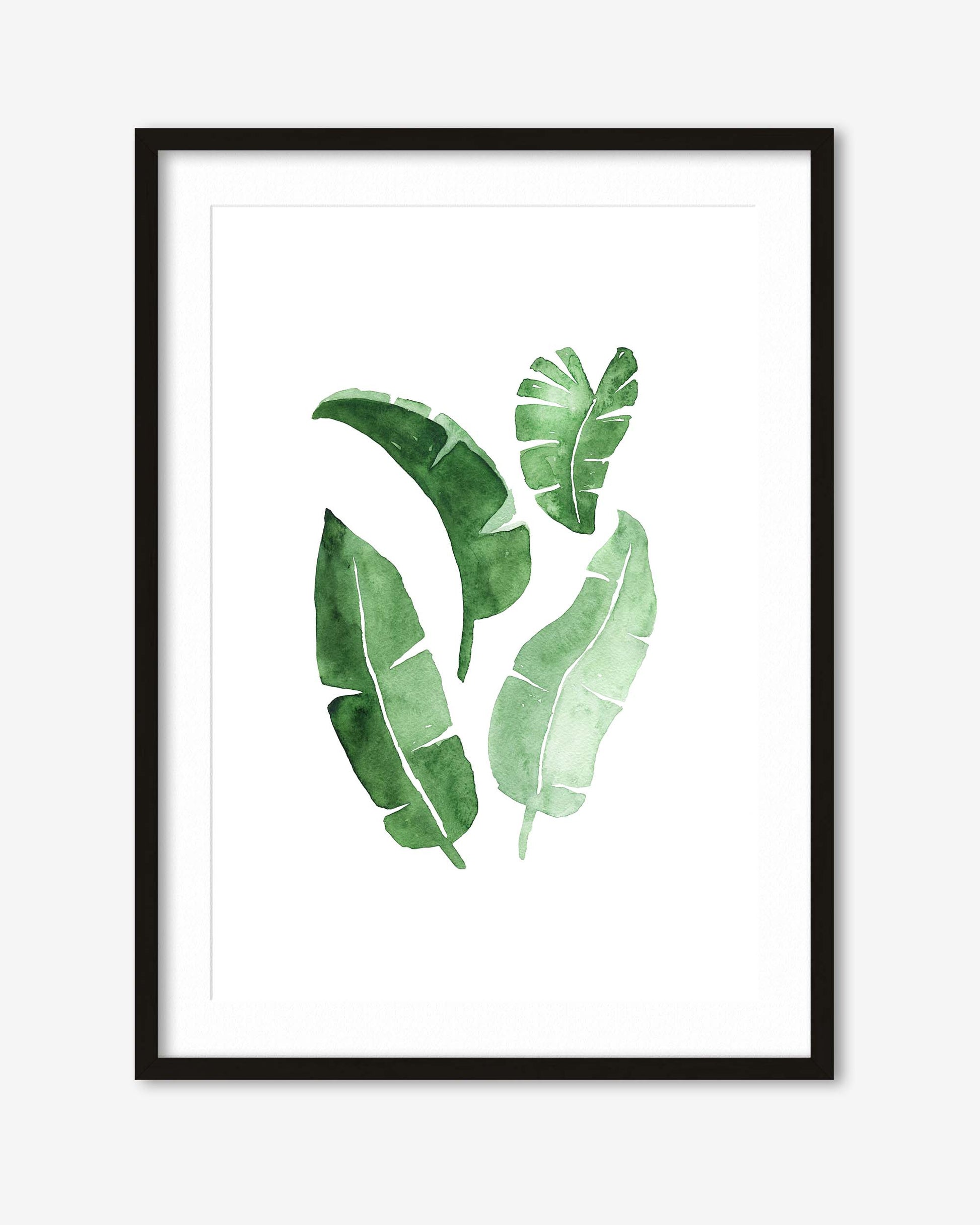framed botanical green leaves art print in a black frame
