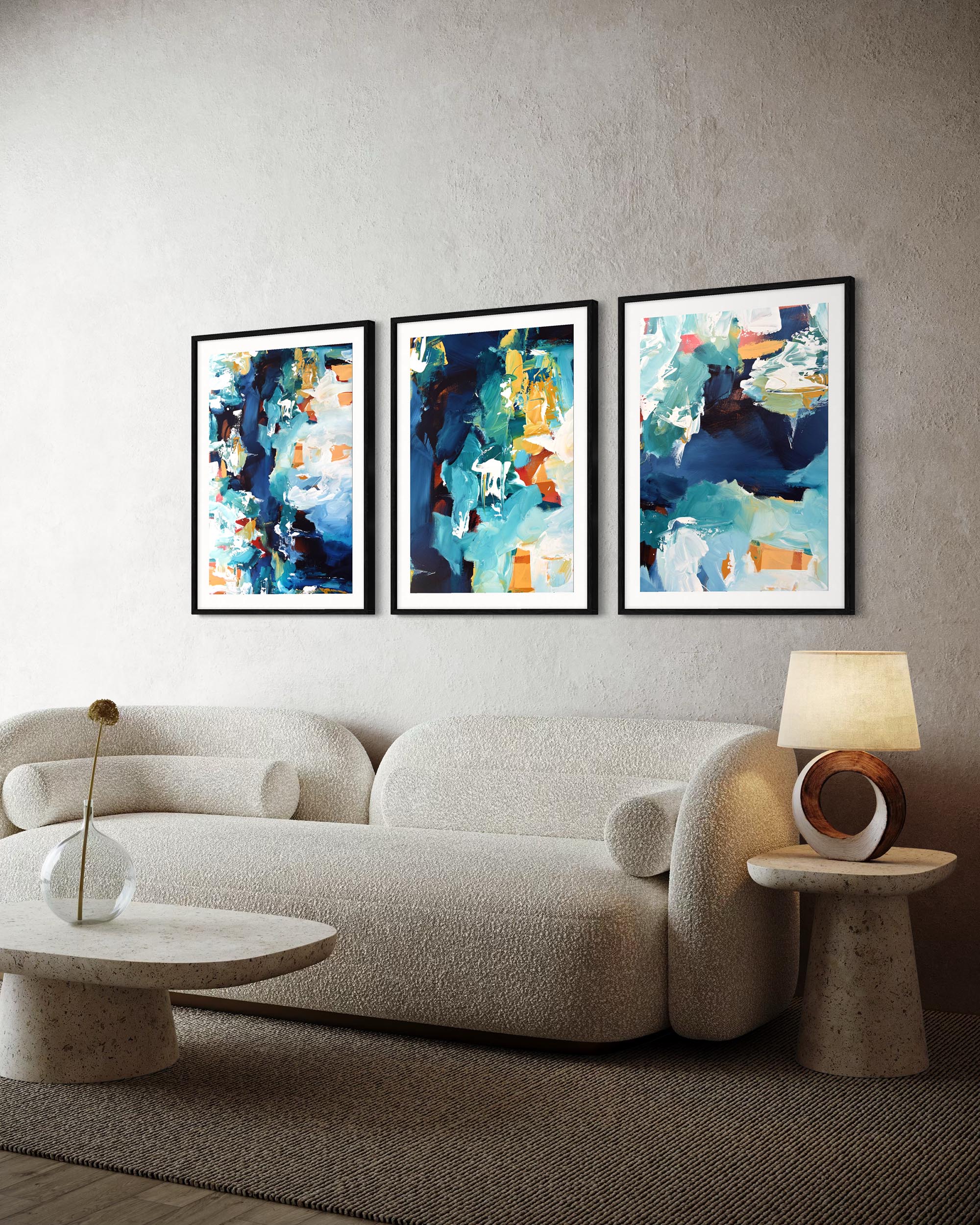 Modern living room with a beige sofa, abstract art on the wall, and a side table with a lamp.