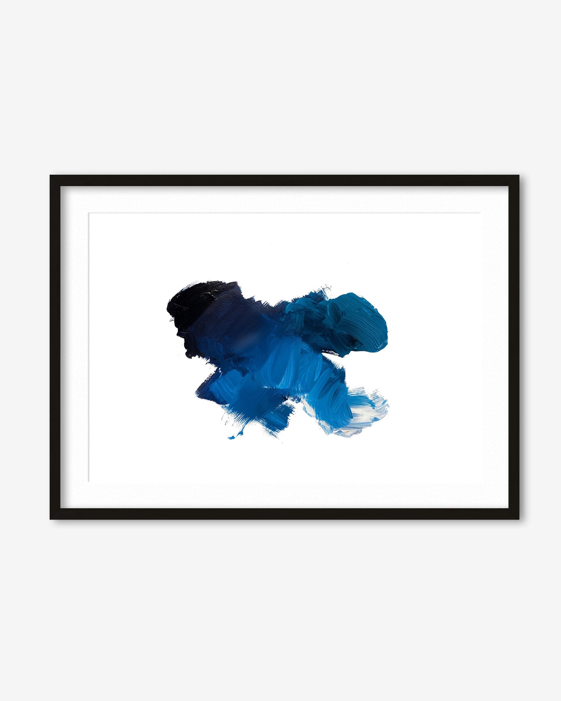 Framed abstract art piece with blue and black ink splashes on a white background