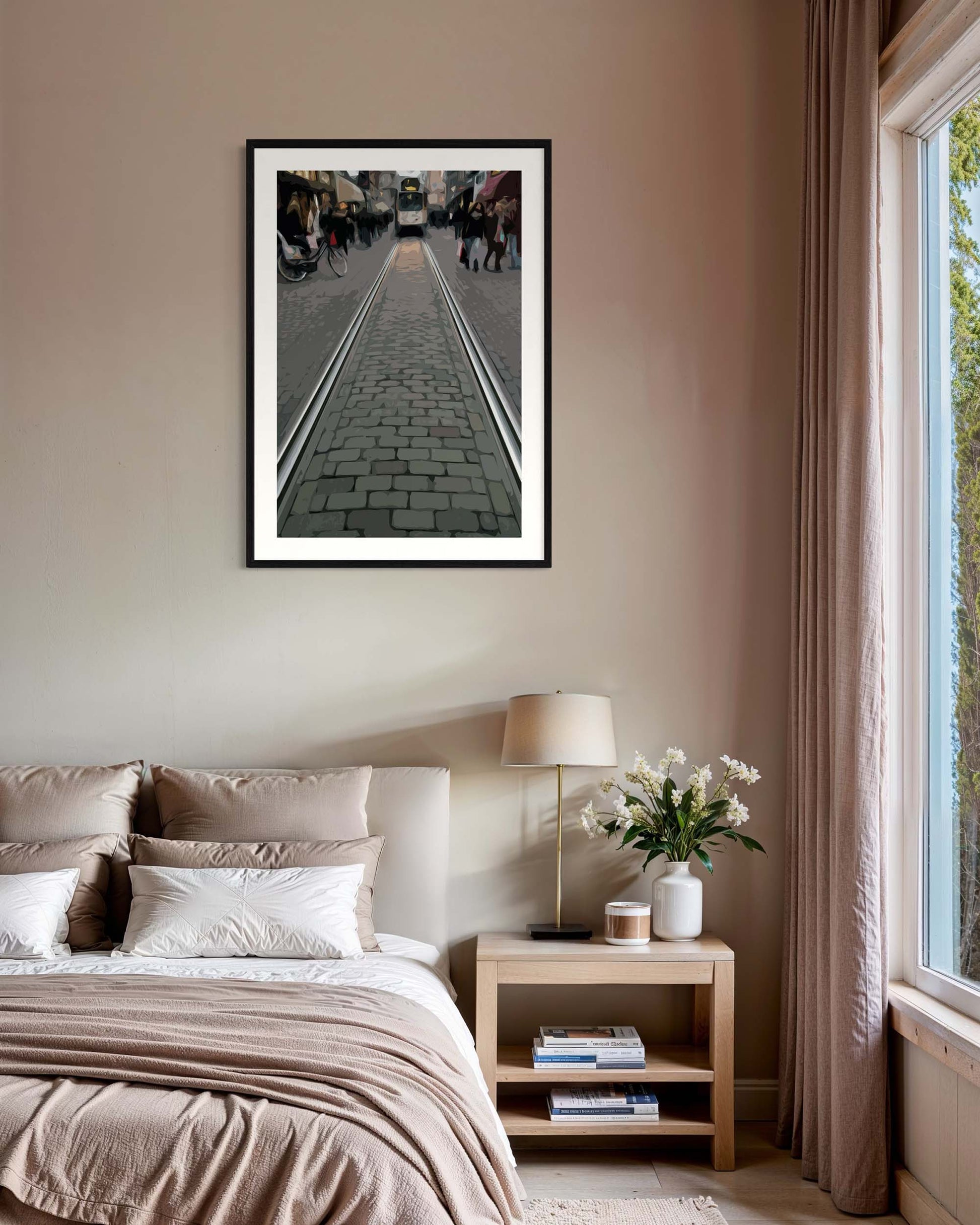 Framed artwork above a bed in a bedroom with a lamp and plant on a nightstand.