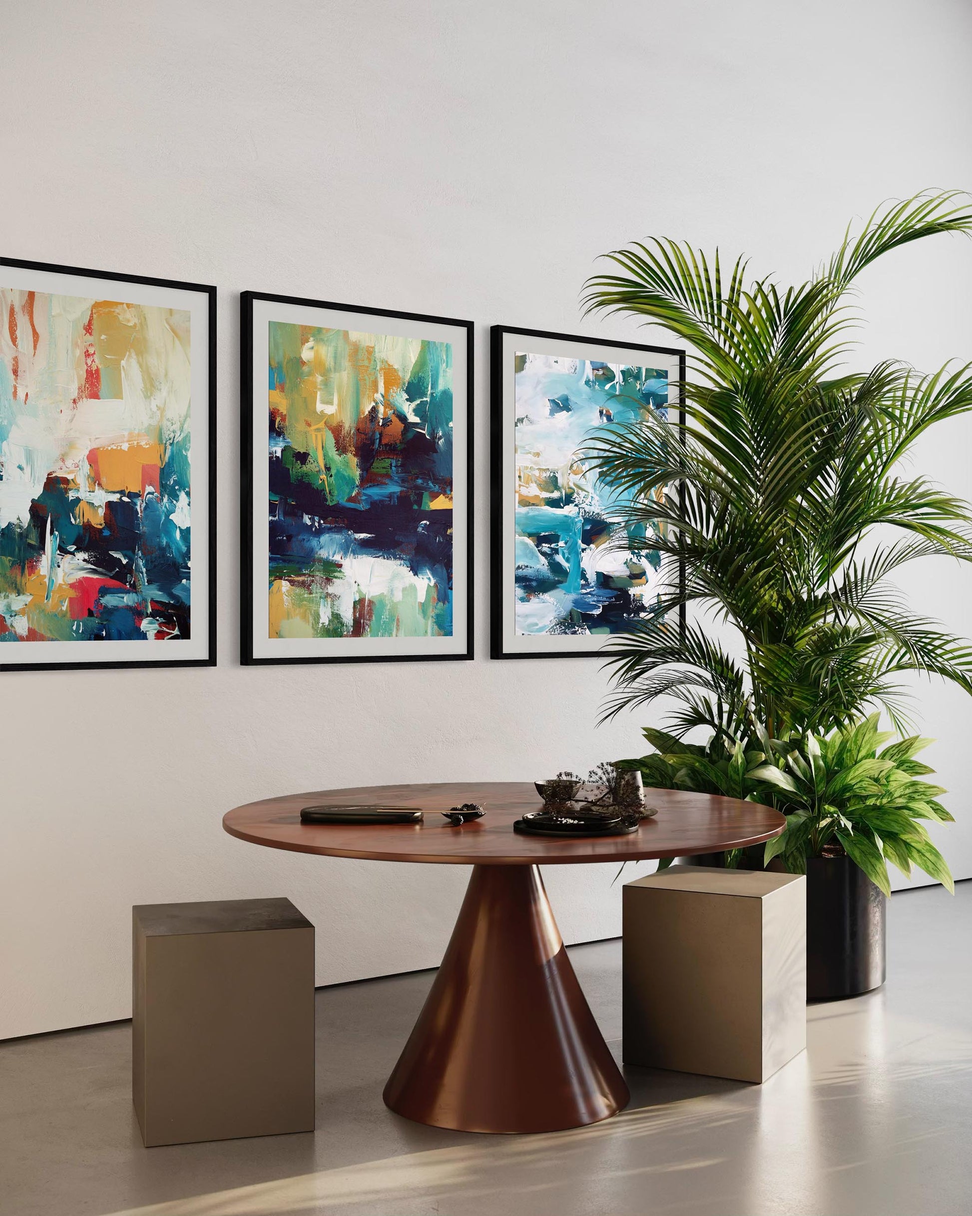 Modern interior with a round wooden table, abstract paintings, and a potted plant.